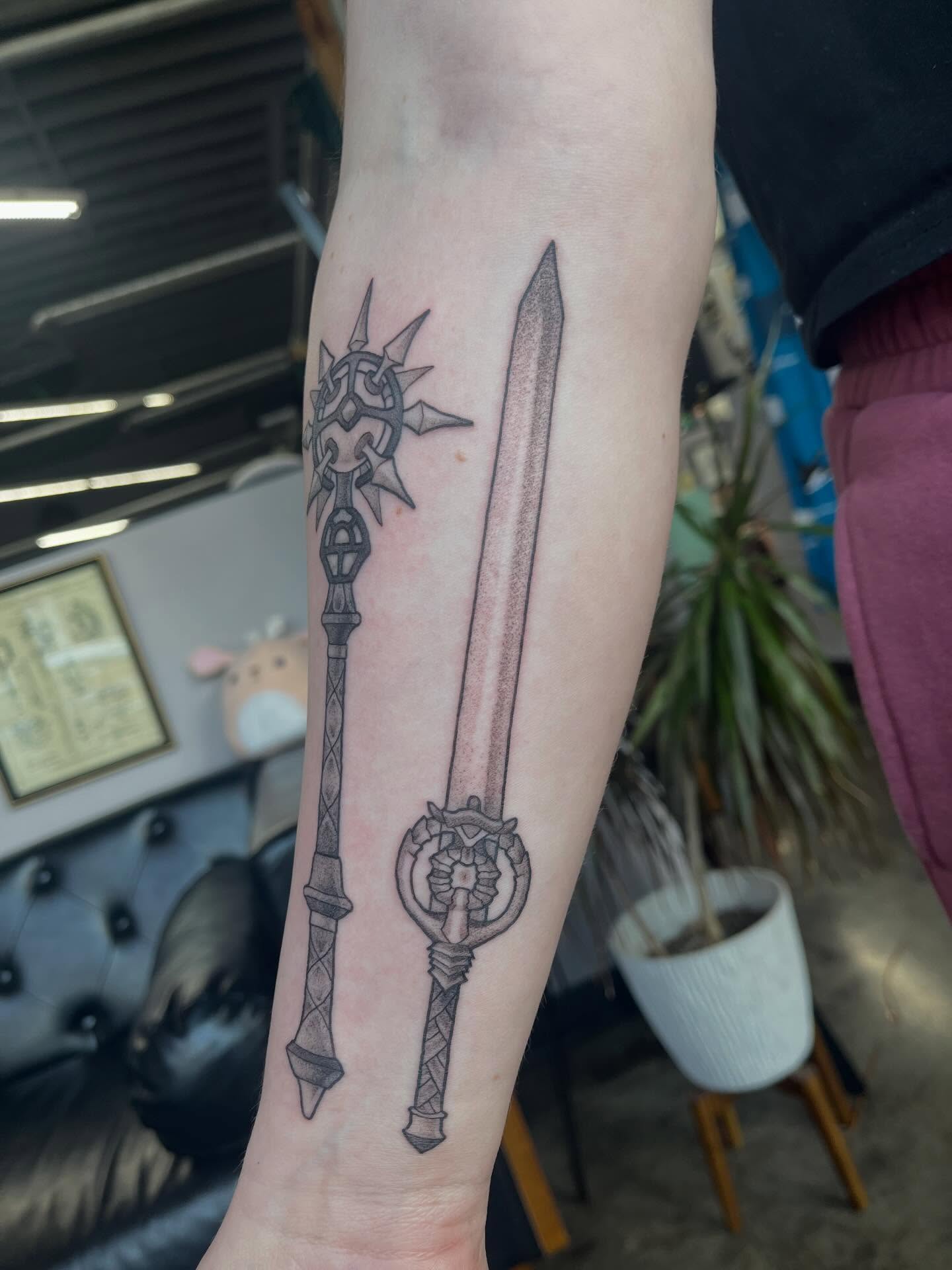 Sword and key black and grey tattoo on the forearm by bunny, Minneapolis, Minnesota