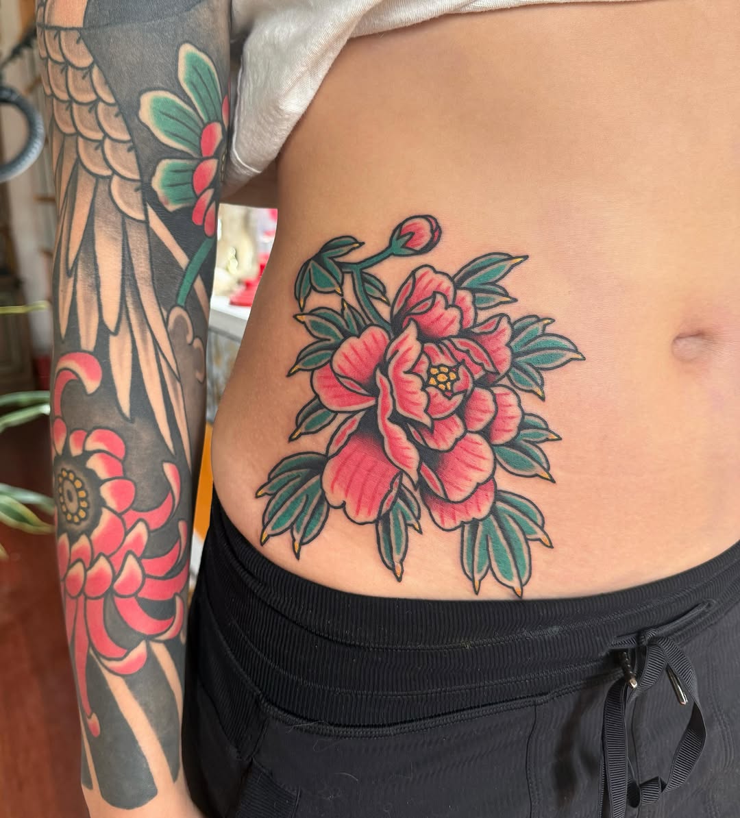 Peony flowers American traditional tattoo on the ribs by ༺tessa༻