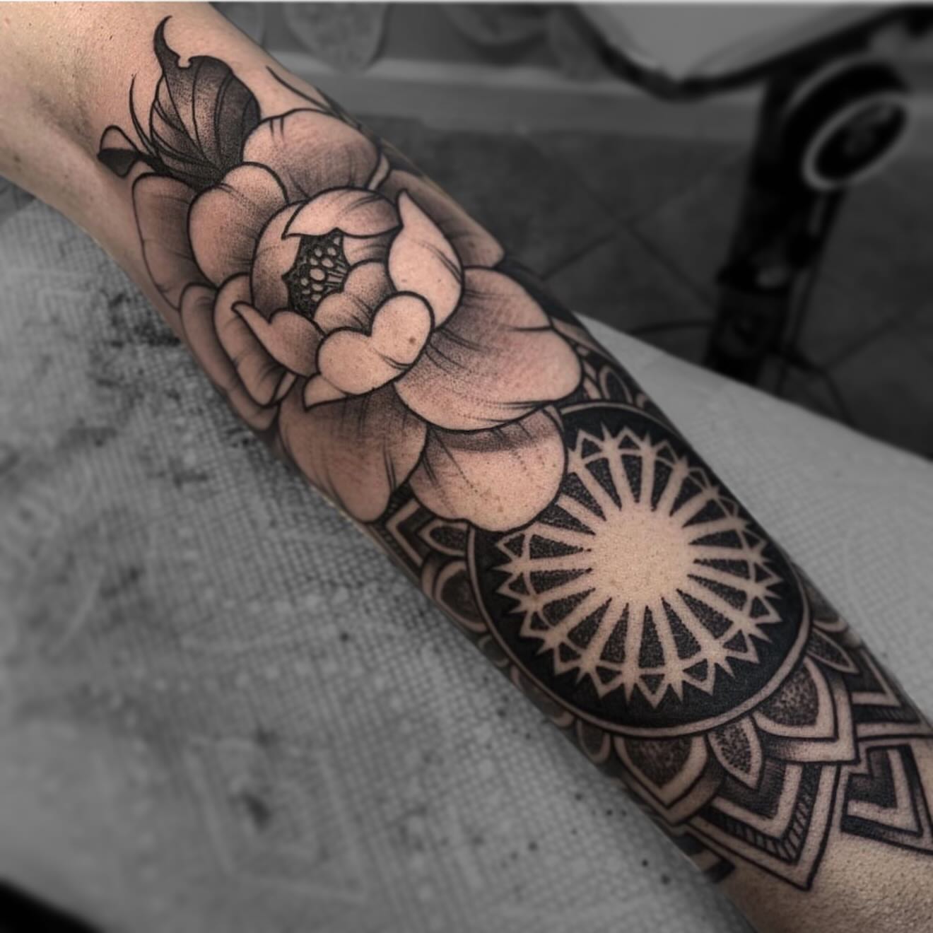 Flower and mandala geometric tattoo on the forearm by Alex Rockoff
