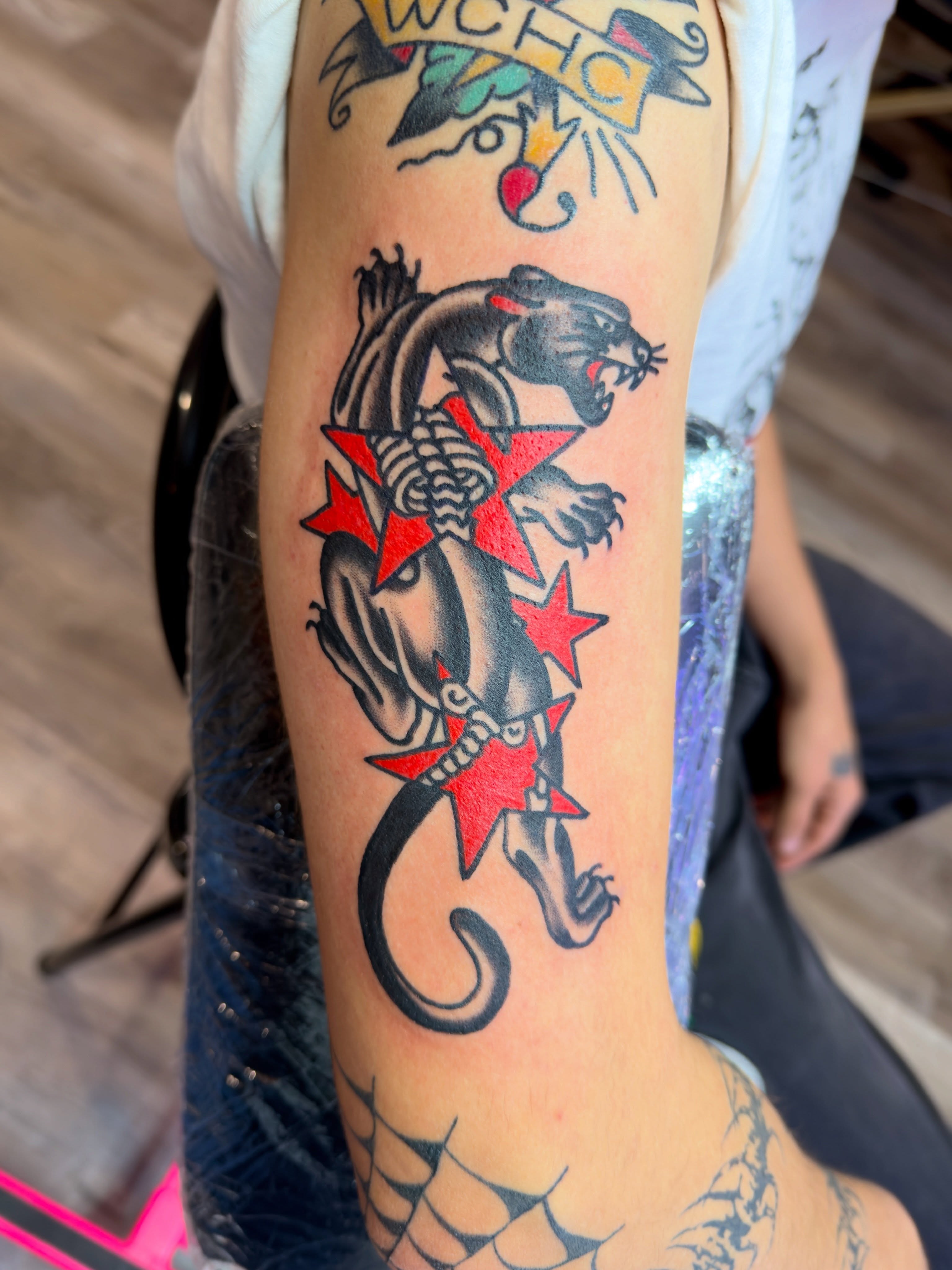 Panther with stars American traditional tattoo on the forearm by Jimmy Kelley