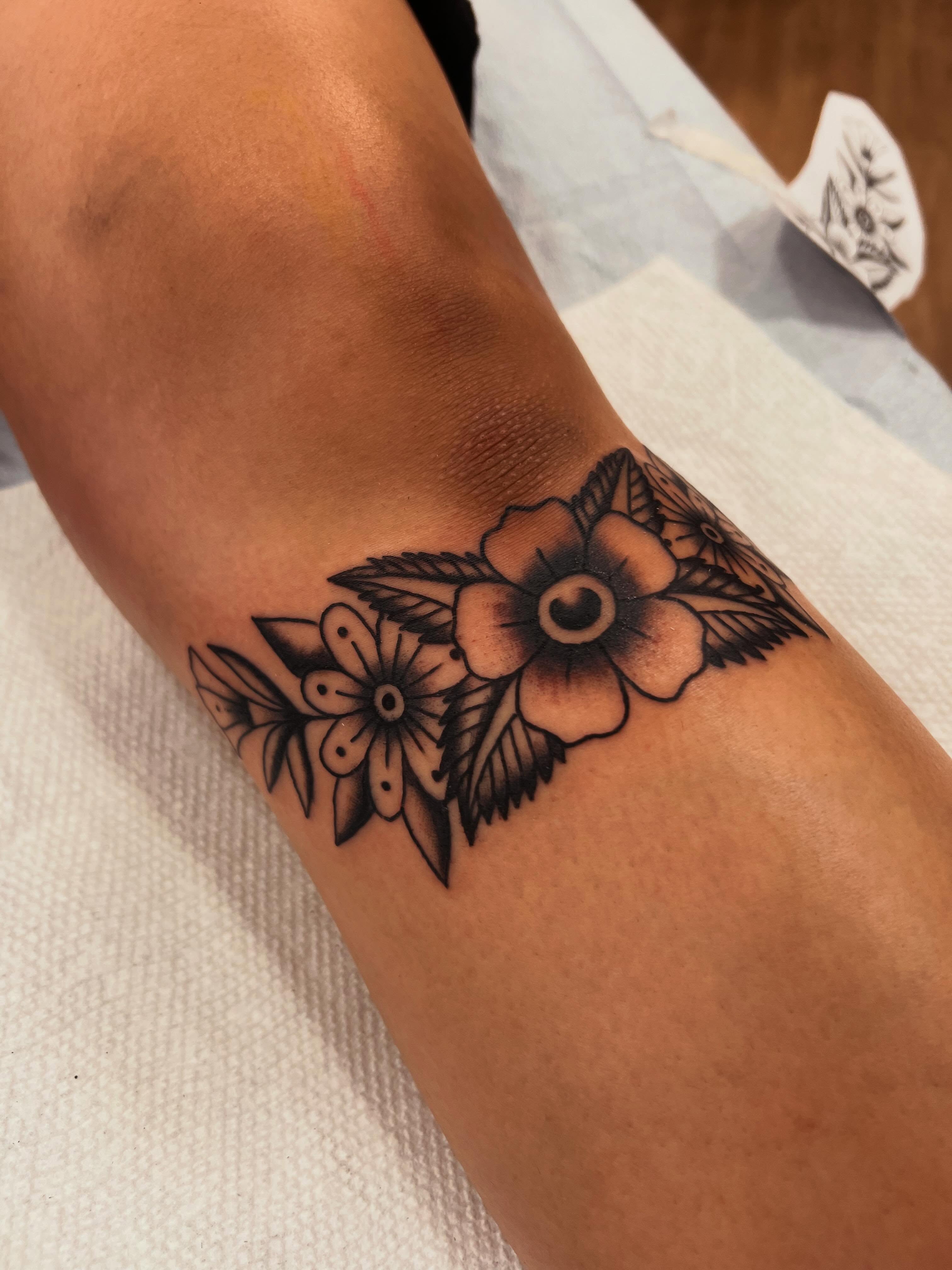 Floral arrangement black and grey tattoo on the forearm by Samantha Citer