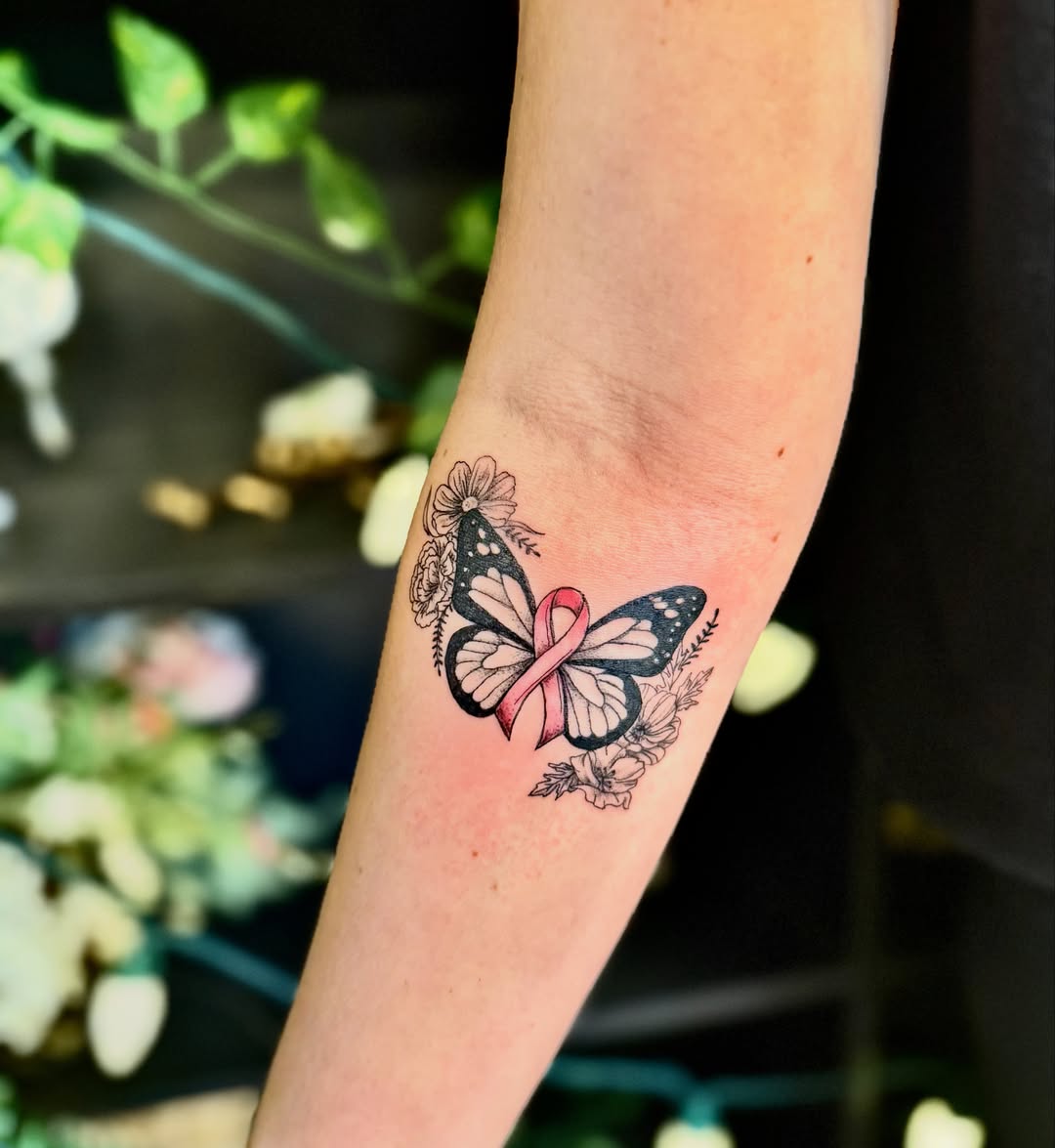 Butterfly with ribbon new school tattoo on the forearm by Haley Bates