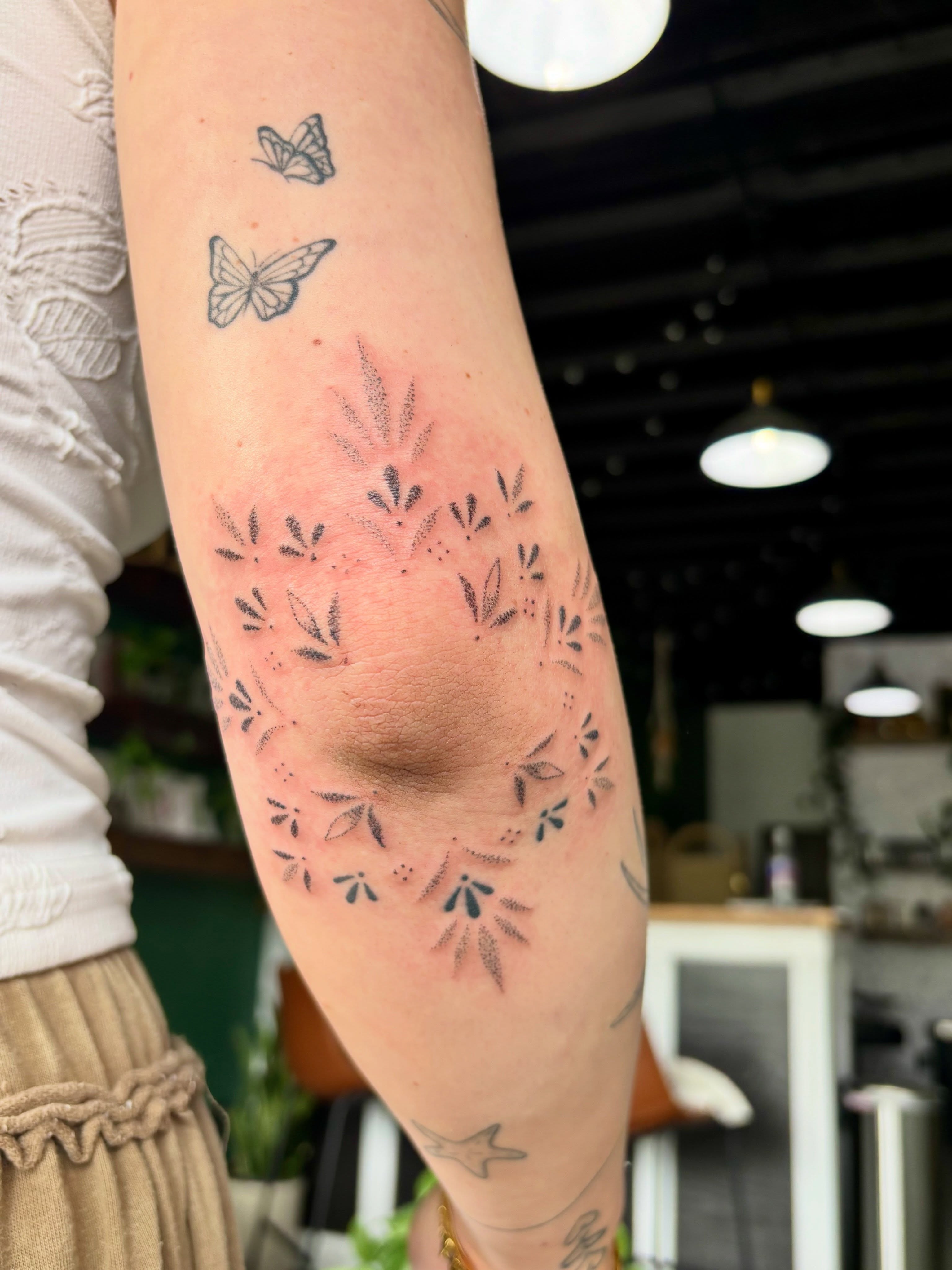 Floral pattern dotwork tattoo on the forearm by Ashley, Elk Horn, Iowa