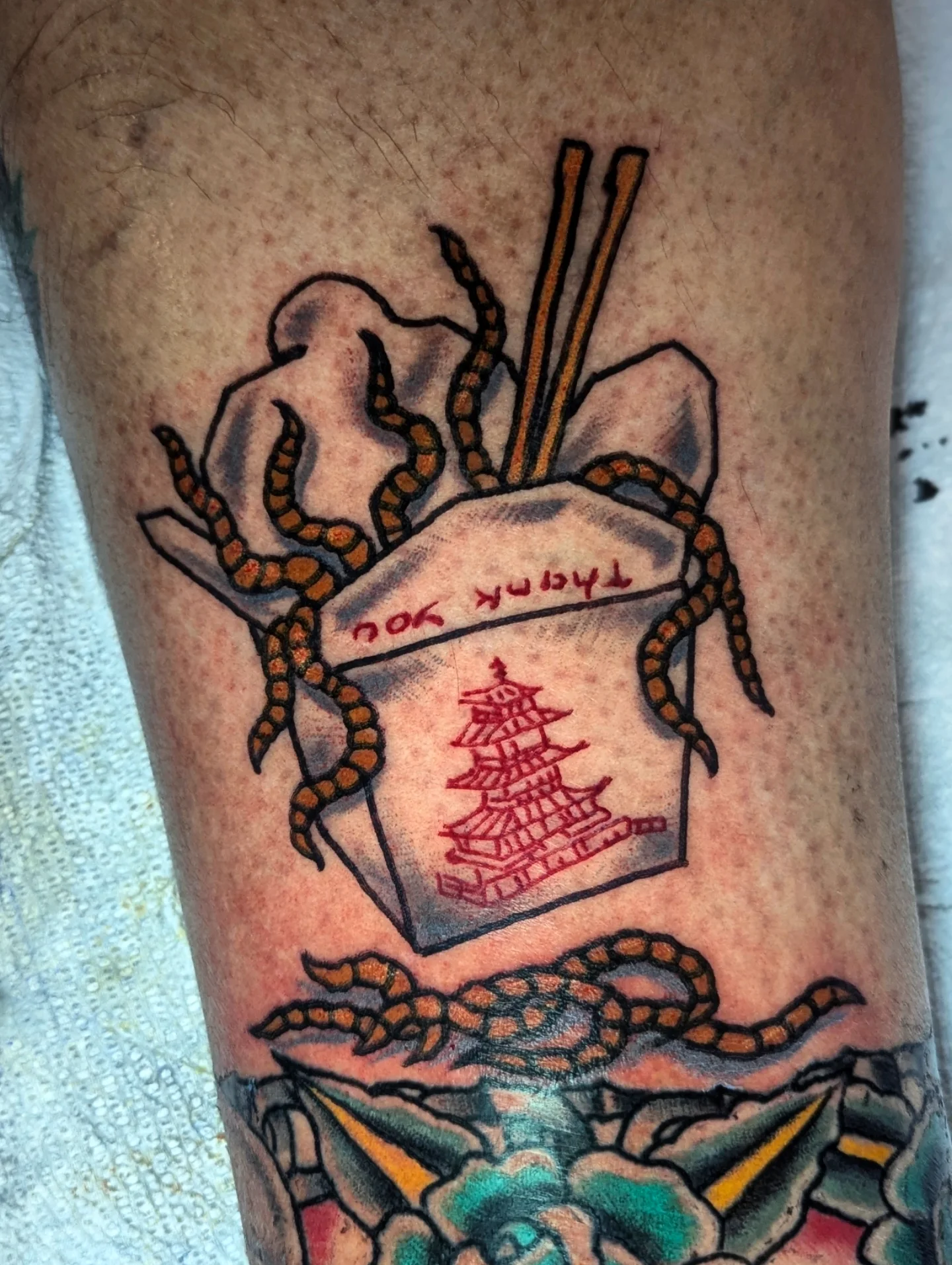 Chinese takeout box American traditional tattoo on the thigh by Eric Ward