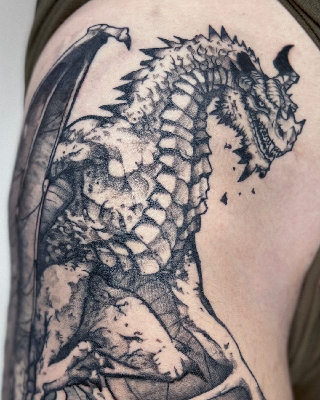 Dragon black and grey tattoo on the shoulder by Kal