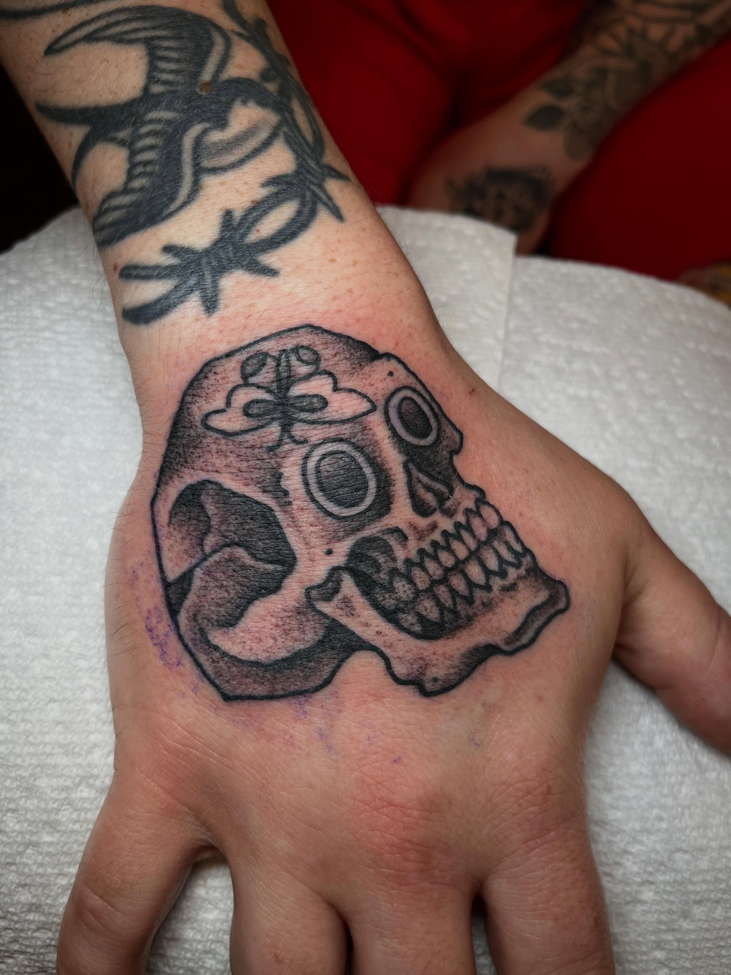 Skull dotwork tattoo on the hand by Chris Kline