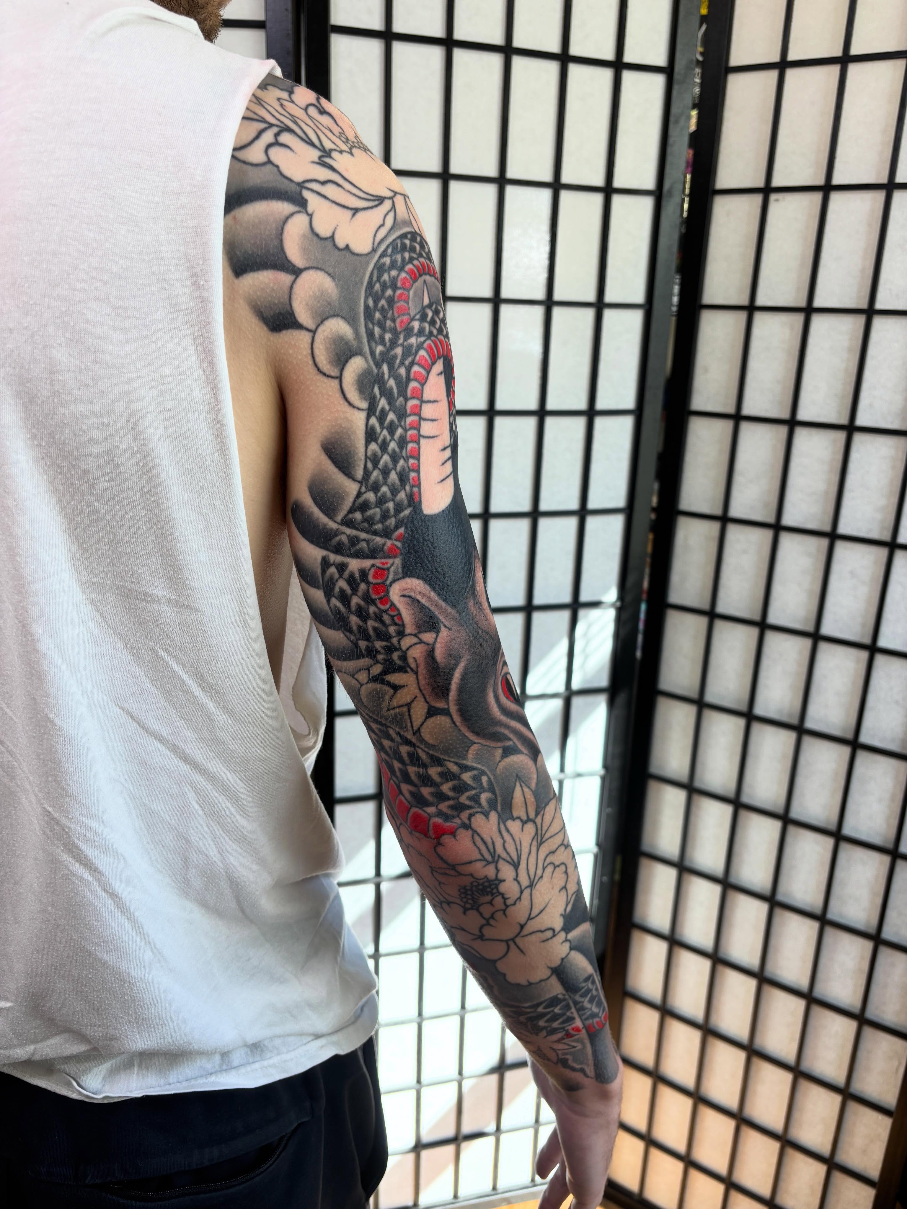 Snake and peony japanese irezumi tattoo on the upper arm by Mike DiCicco