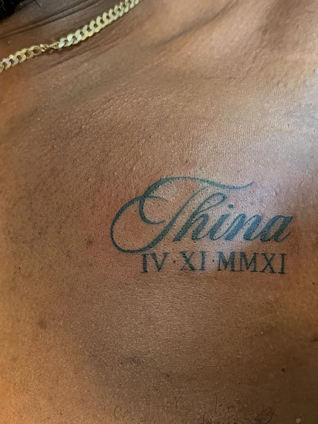 Name and roman numerals tattoo on the chest by TP