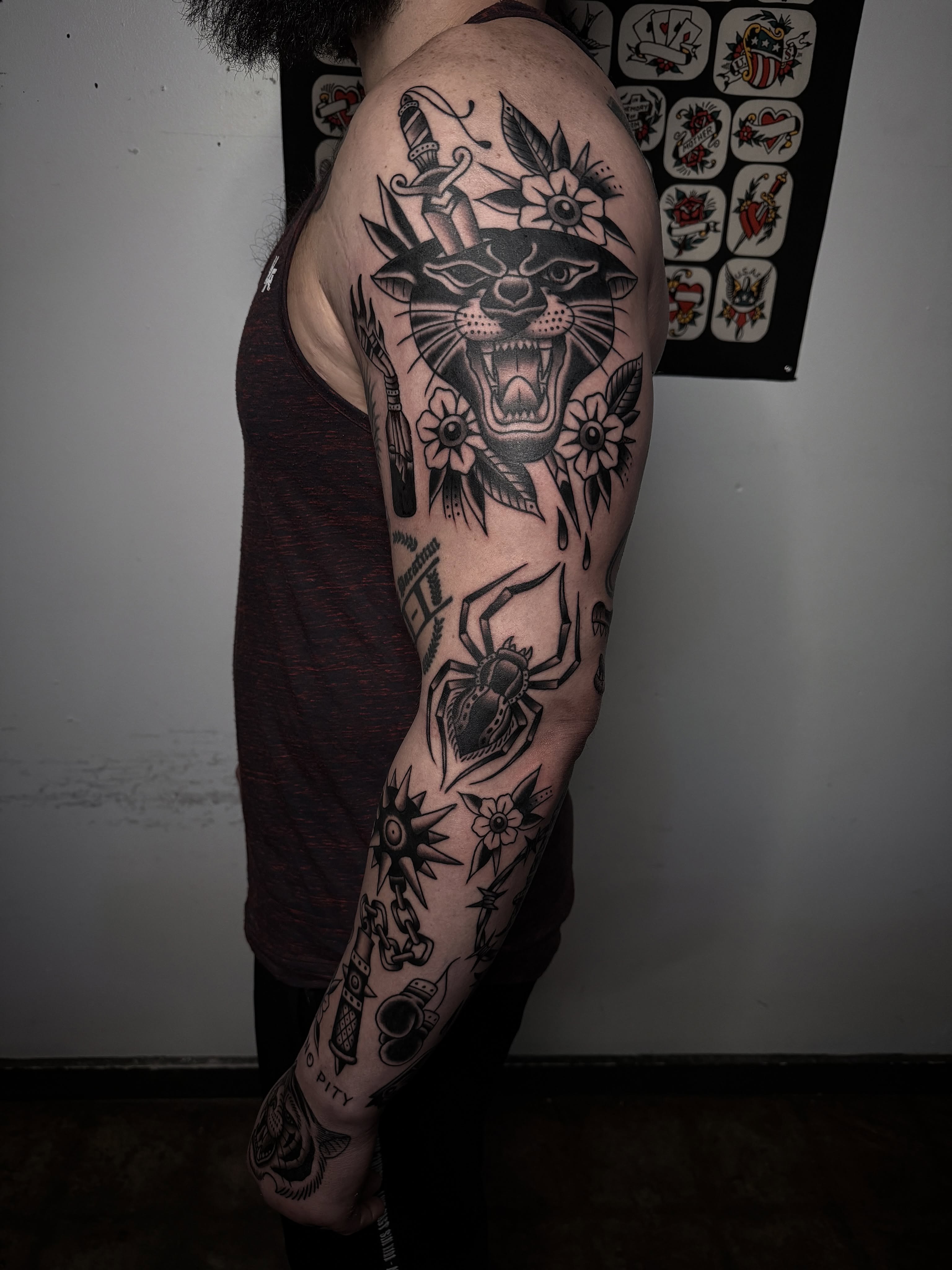 Panther and dagger American traditional tattoo on the upper arm by Cory Craft