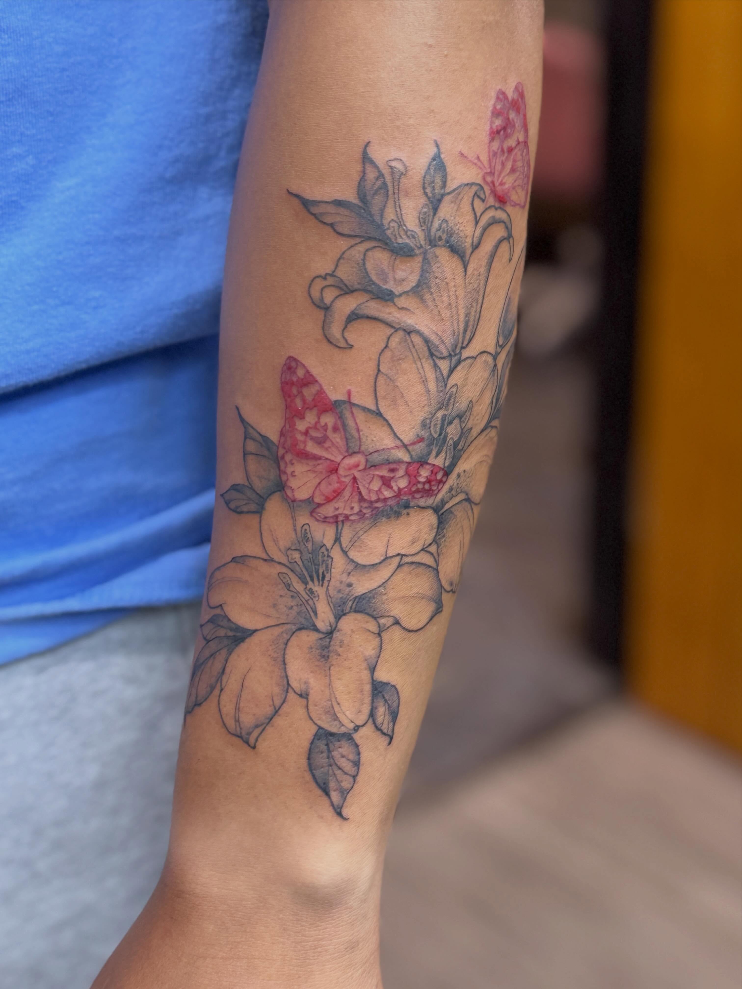 Flowers and butterflies realism tattoo on the forearm by Rebecca Rose
