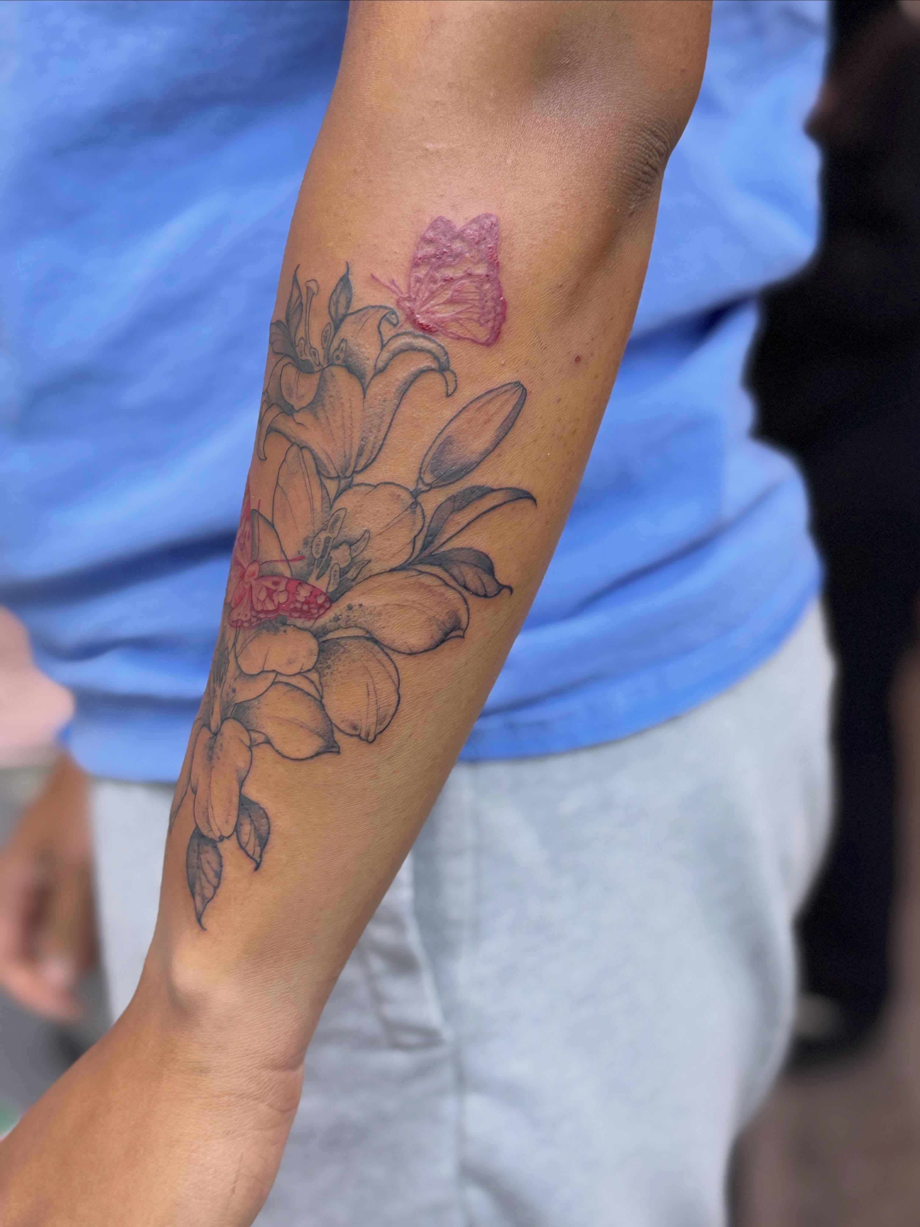 Flowers and butterfly black and grey tattoo on the forearm by Rebecca Rose