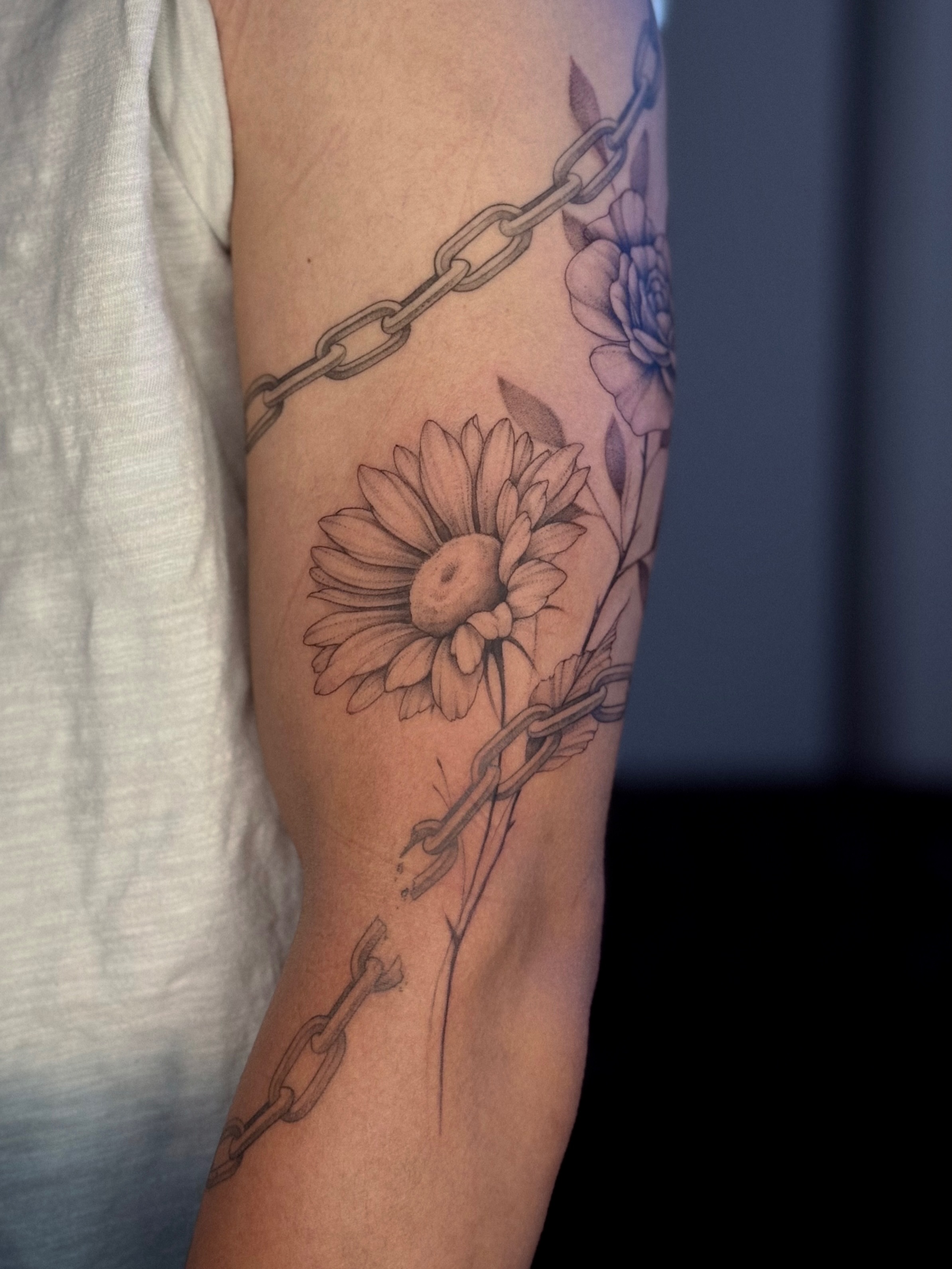 Flower and chain realism tattoo on the forearm by Daria
