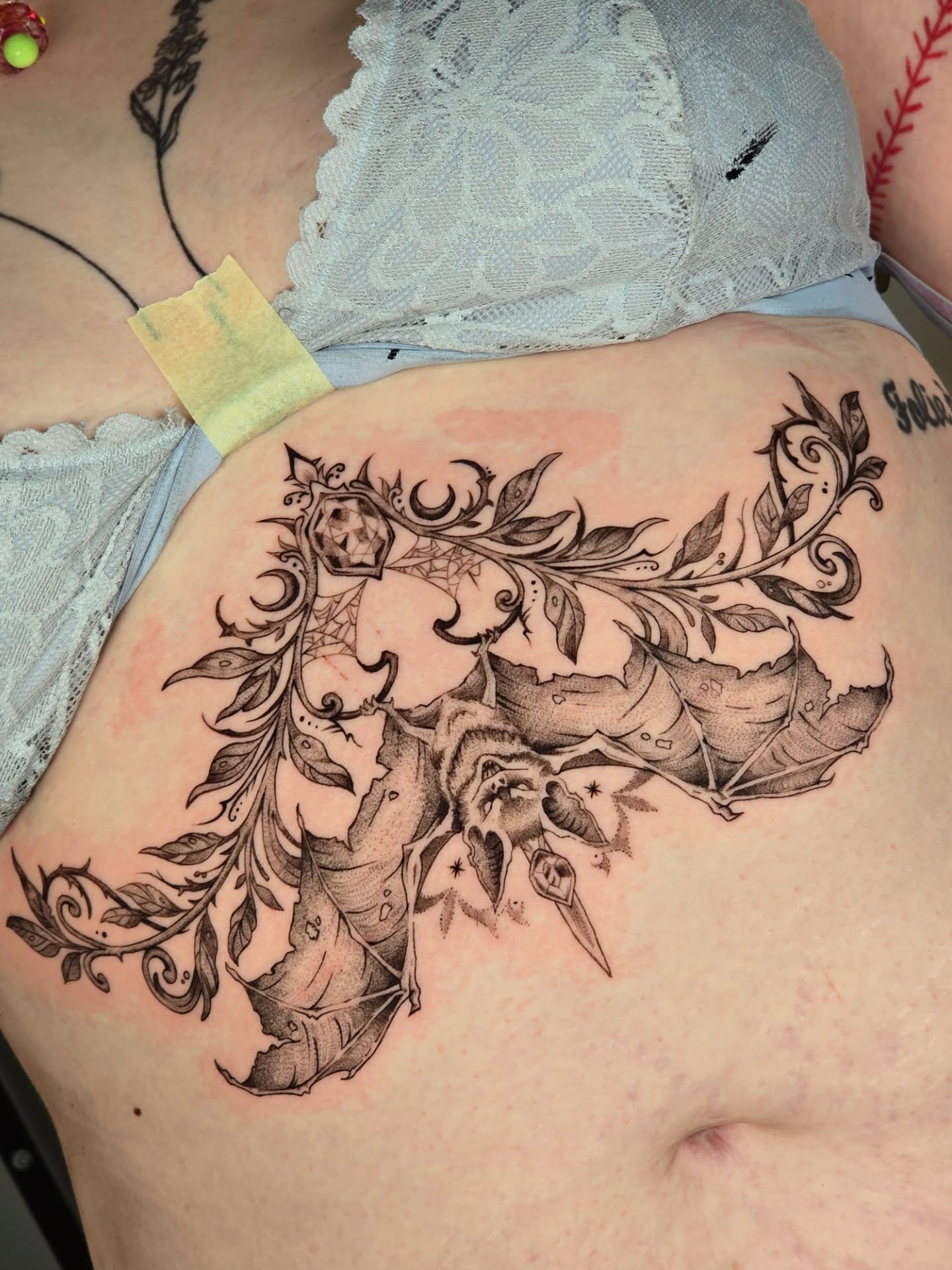 Tree and foliage black and grey tattoo on the back by Scribbles (Teala René), Charlotte, North Carolina