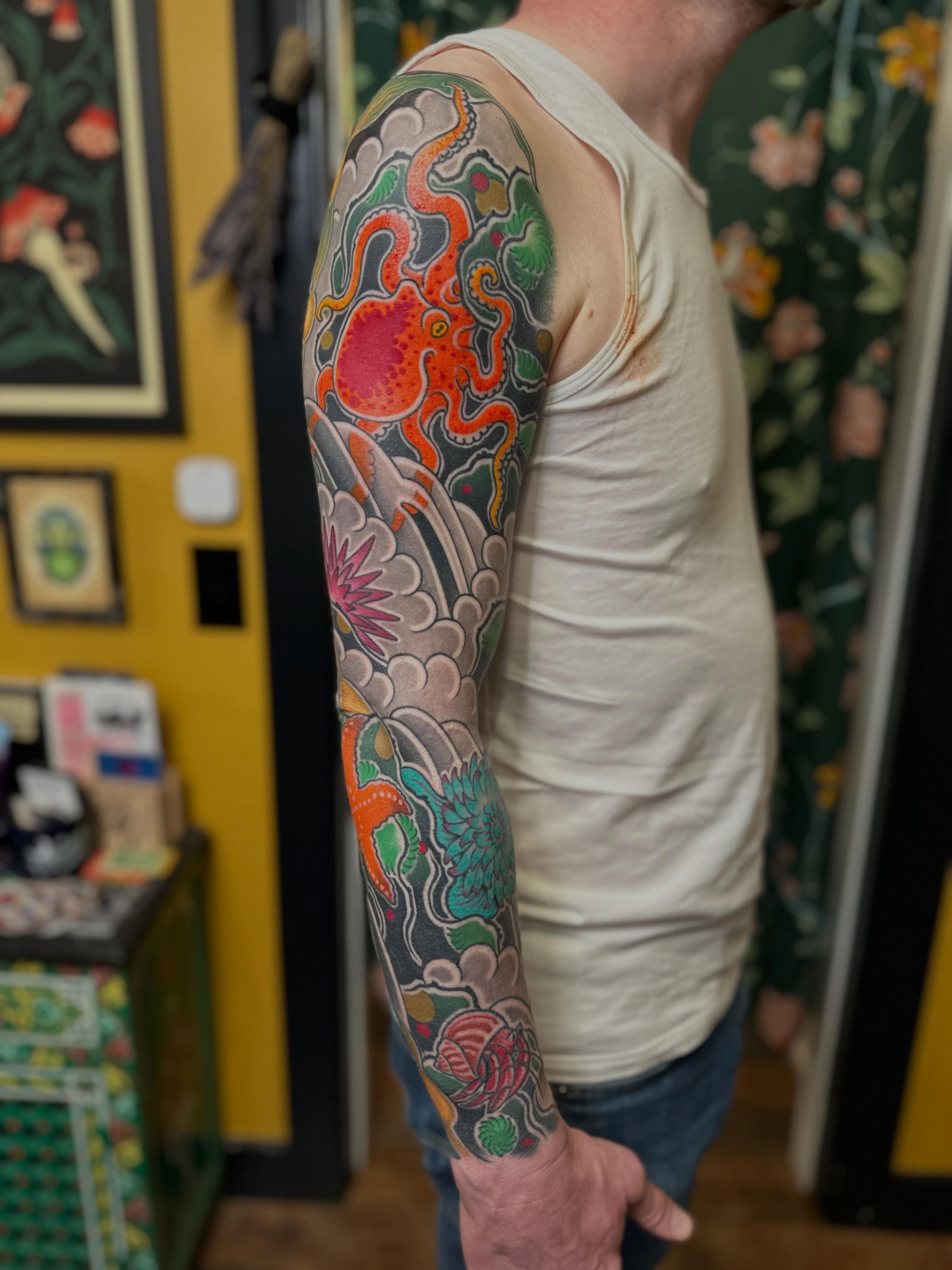 Octopus and floral japanese irezumi tattoo on the upper arm by Megon Shore, Seattle, Washington