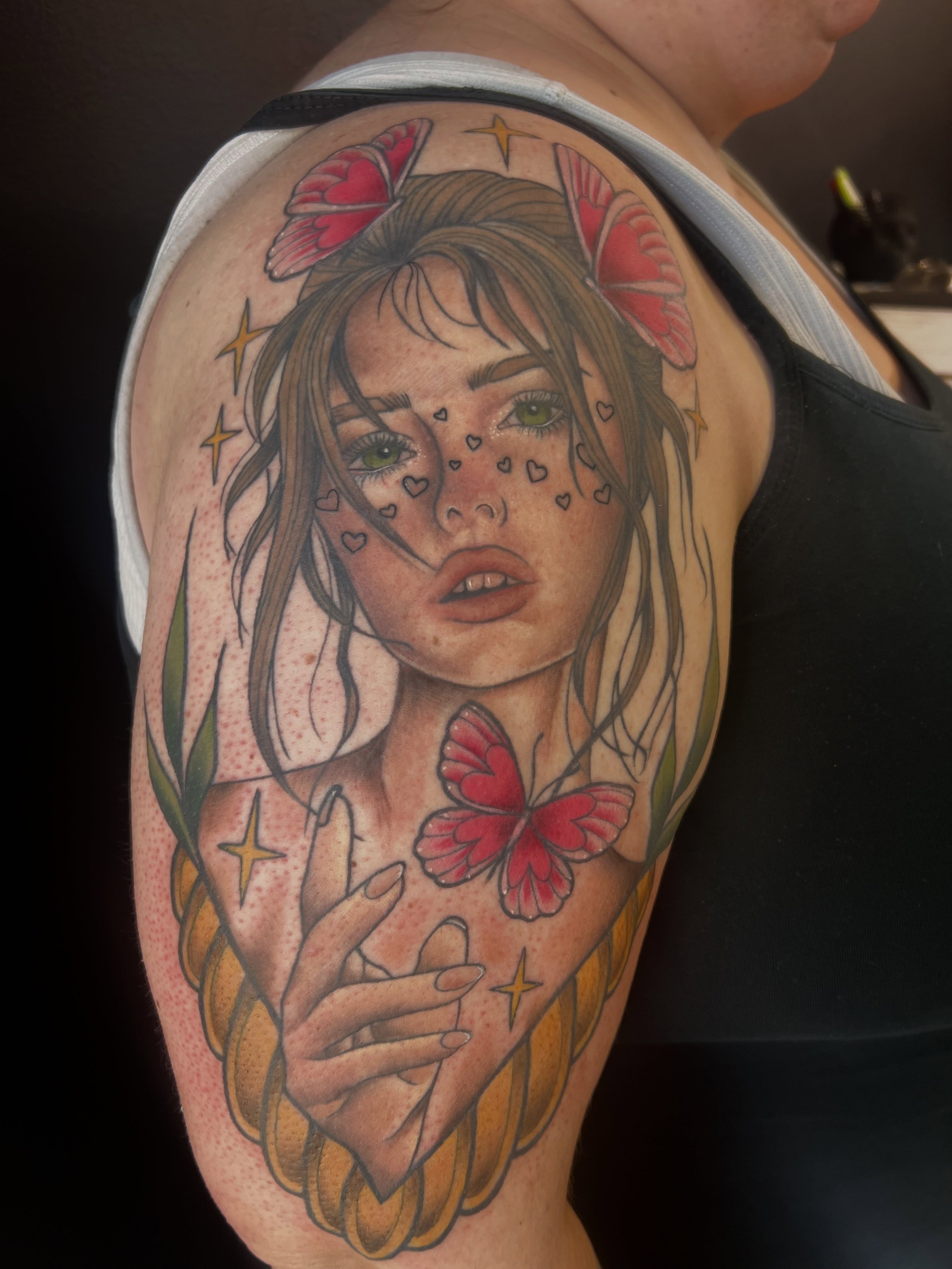 Woman with butterfly realism tattoo on the shoulder by Olivia Suzanne Fada