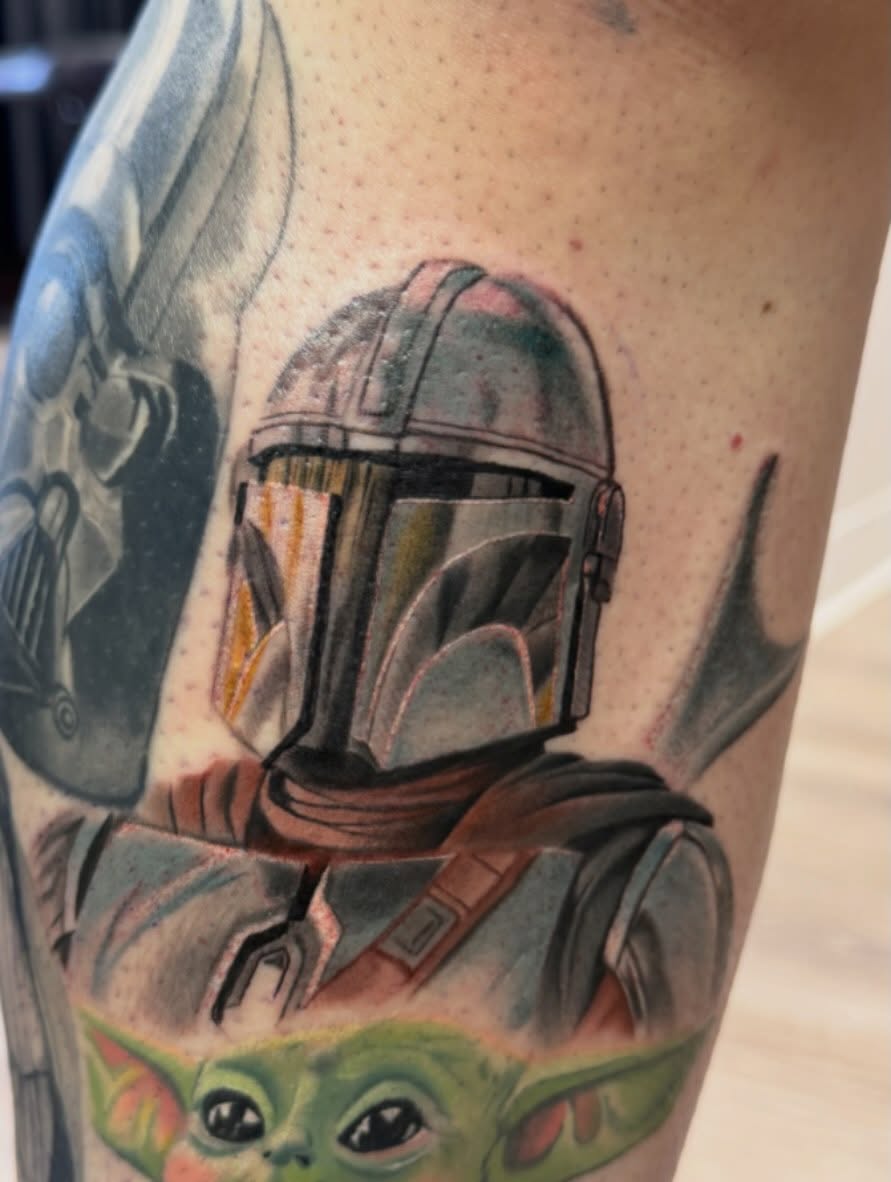 Mandalorian helmet realism tattoo on the forearm by Murbee