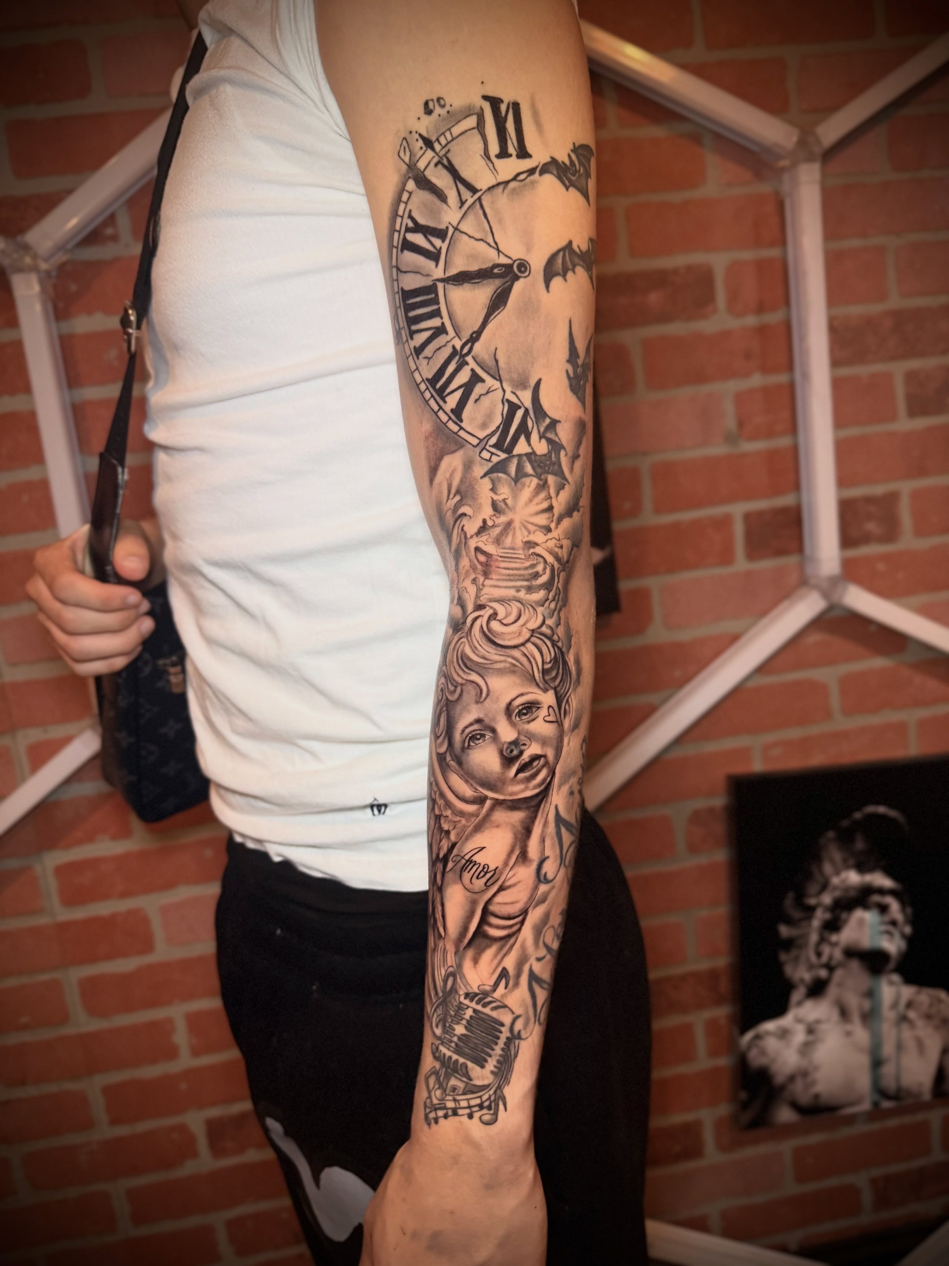 Clock and cherub realism tattoo on the forearm by Andres Calvo🇺🇸🇨🇴