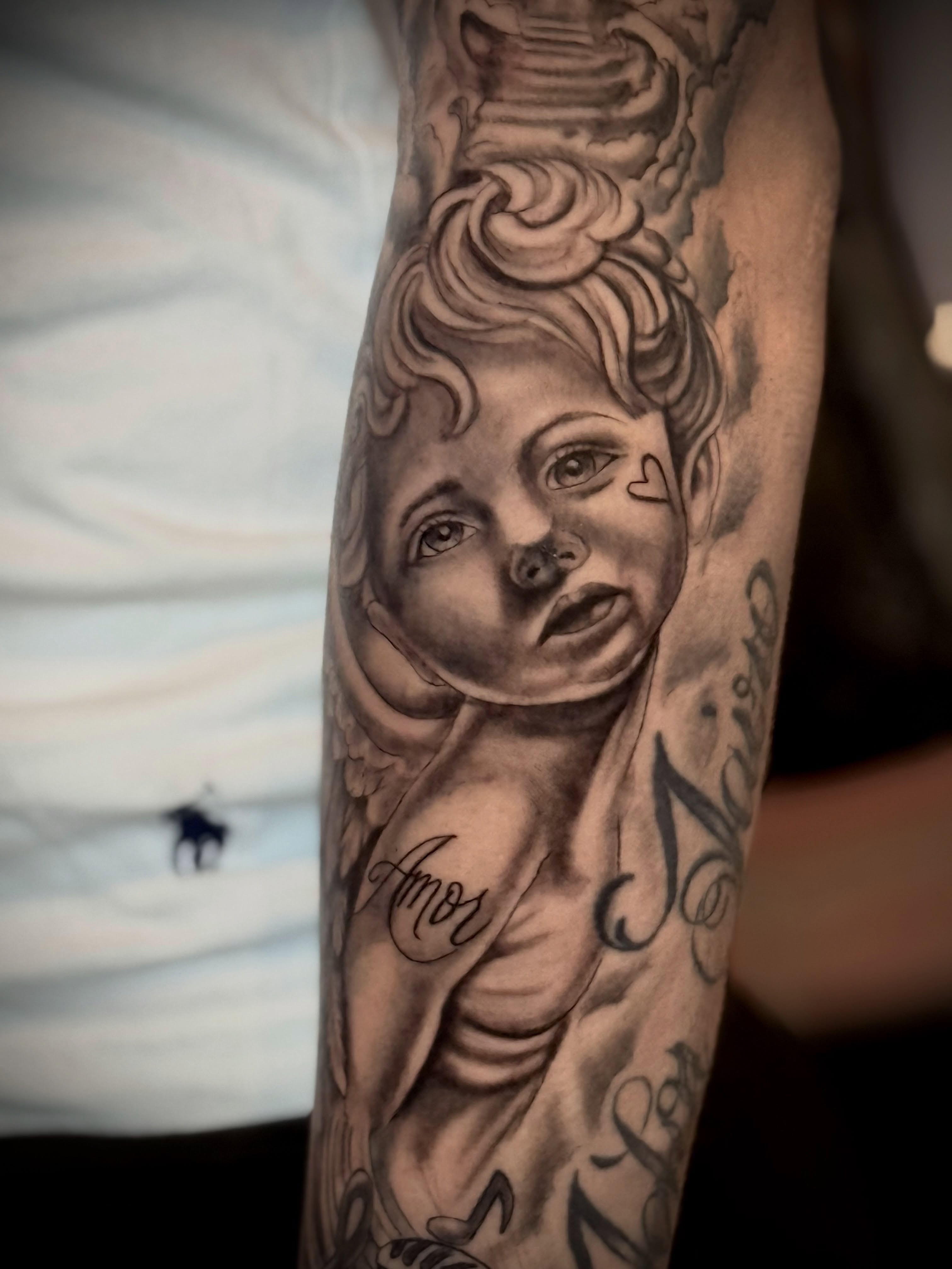 Cherub realism tattoo on the forearm by Andres Calvo🇺🇸🇨🇴