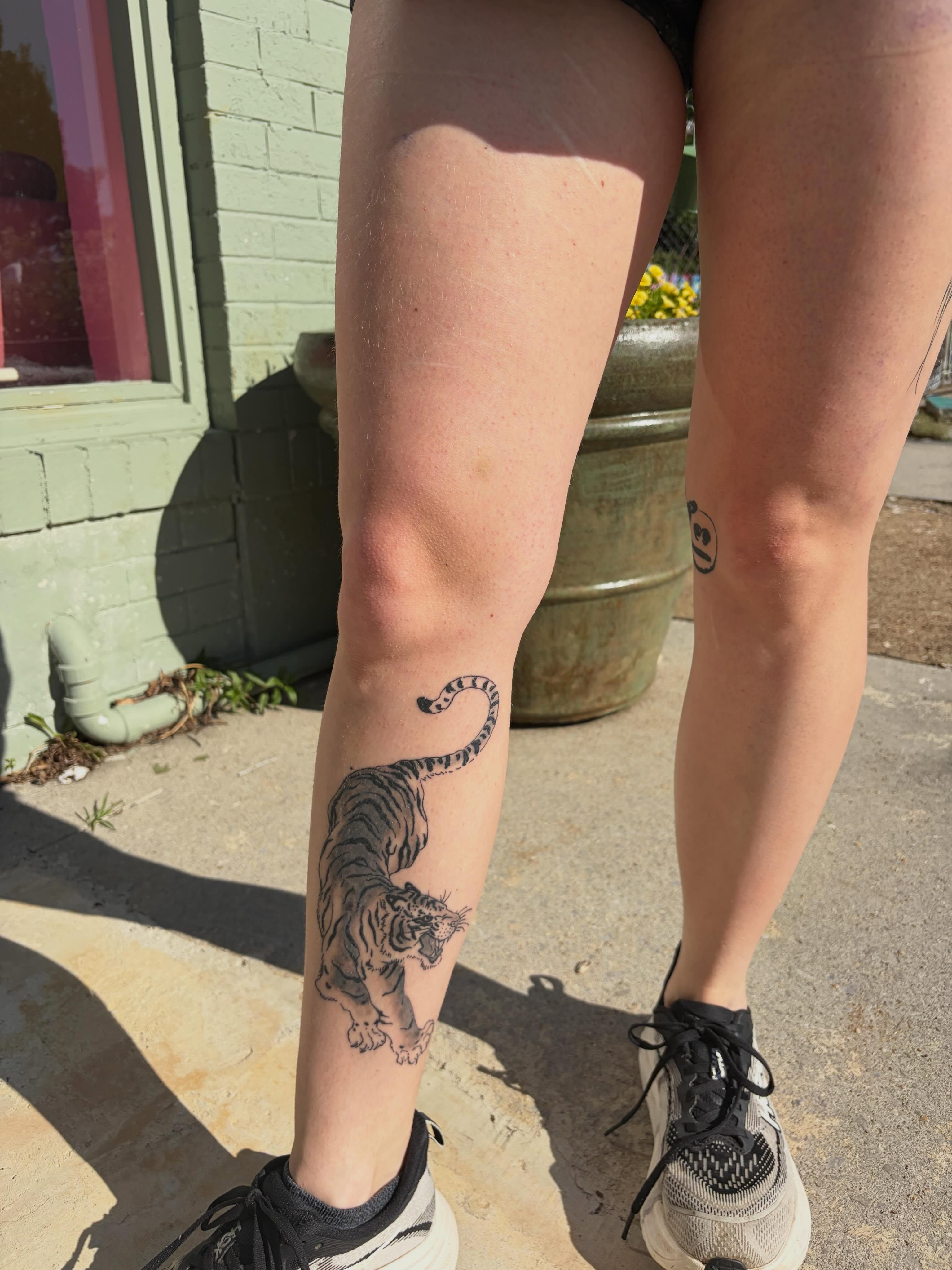 Tiger black and grey tattoo on the calf by neal
