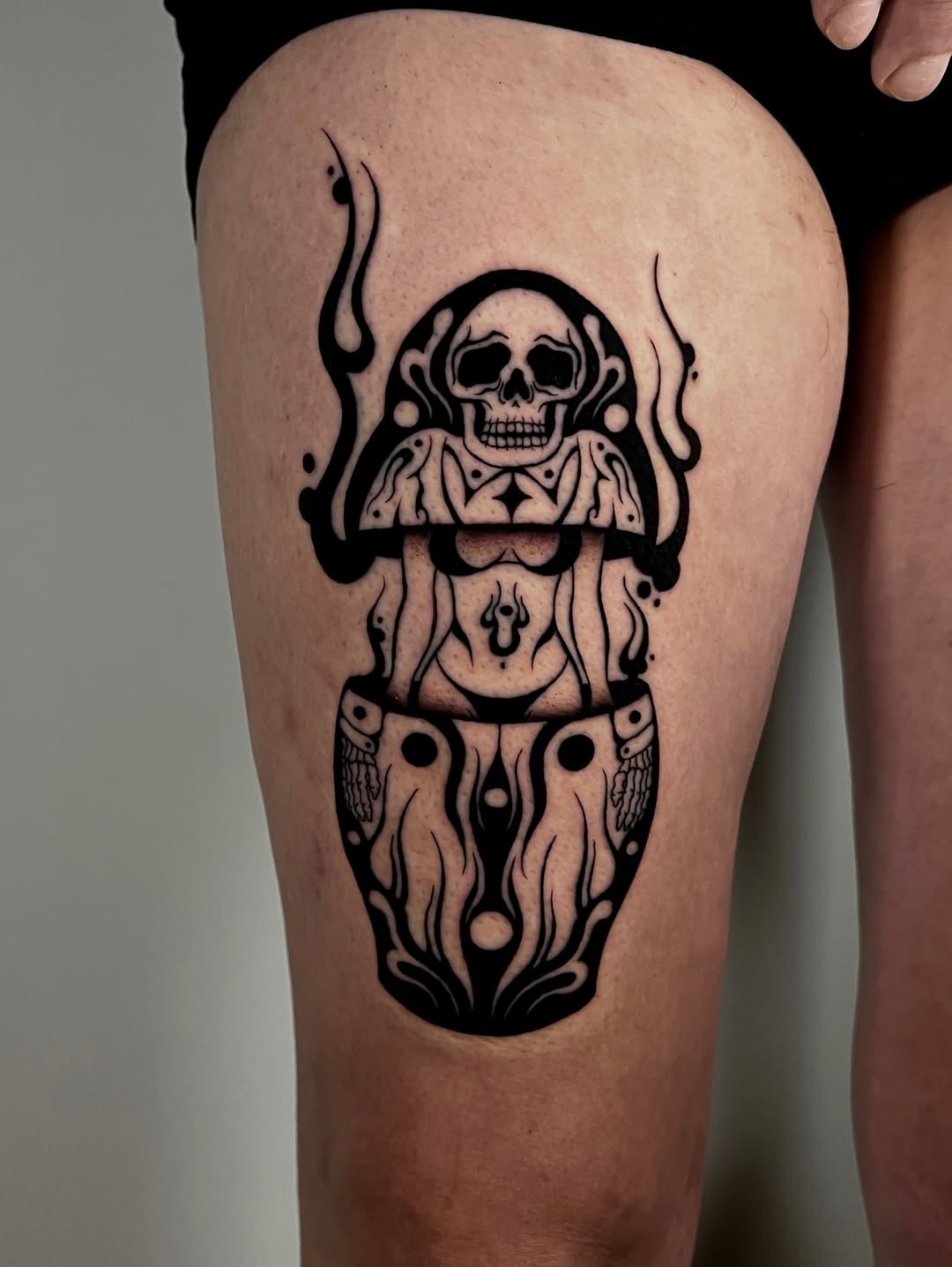 Mushroom with skull black and grey tattoo on the thigh by Rebel milly Tattoo