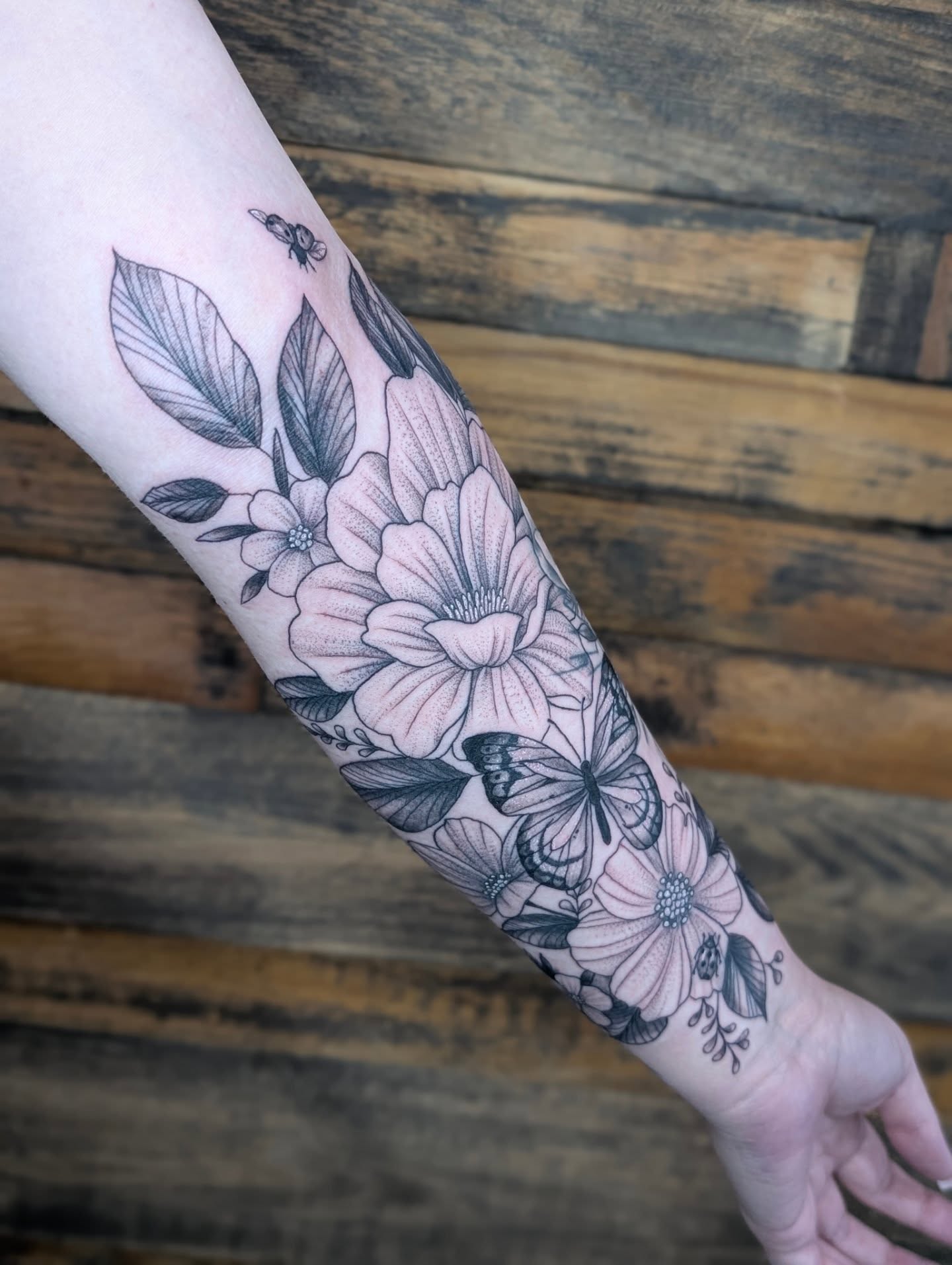 Floral bouquet black and grey tattoo on the forearm by SHOP53 Tattoo & Art