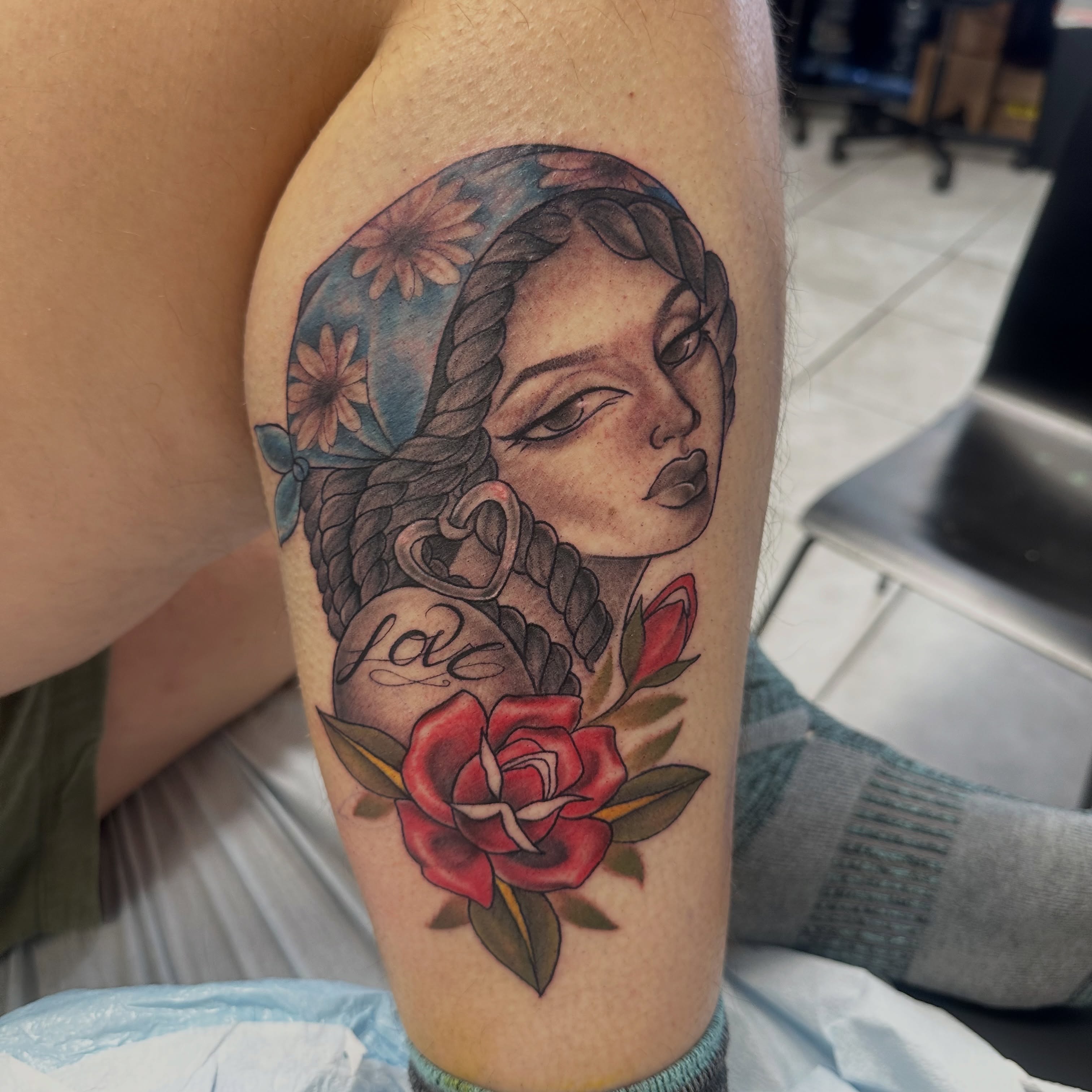 Woman's face with rope and rose American traditional tattoo on the forearm by Mia Layne 🤎