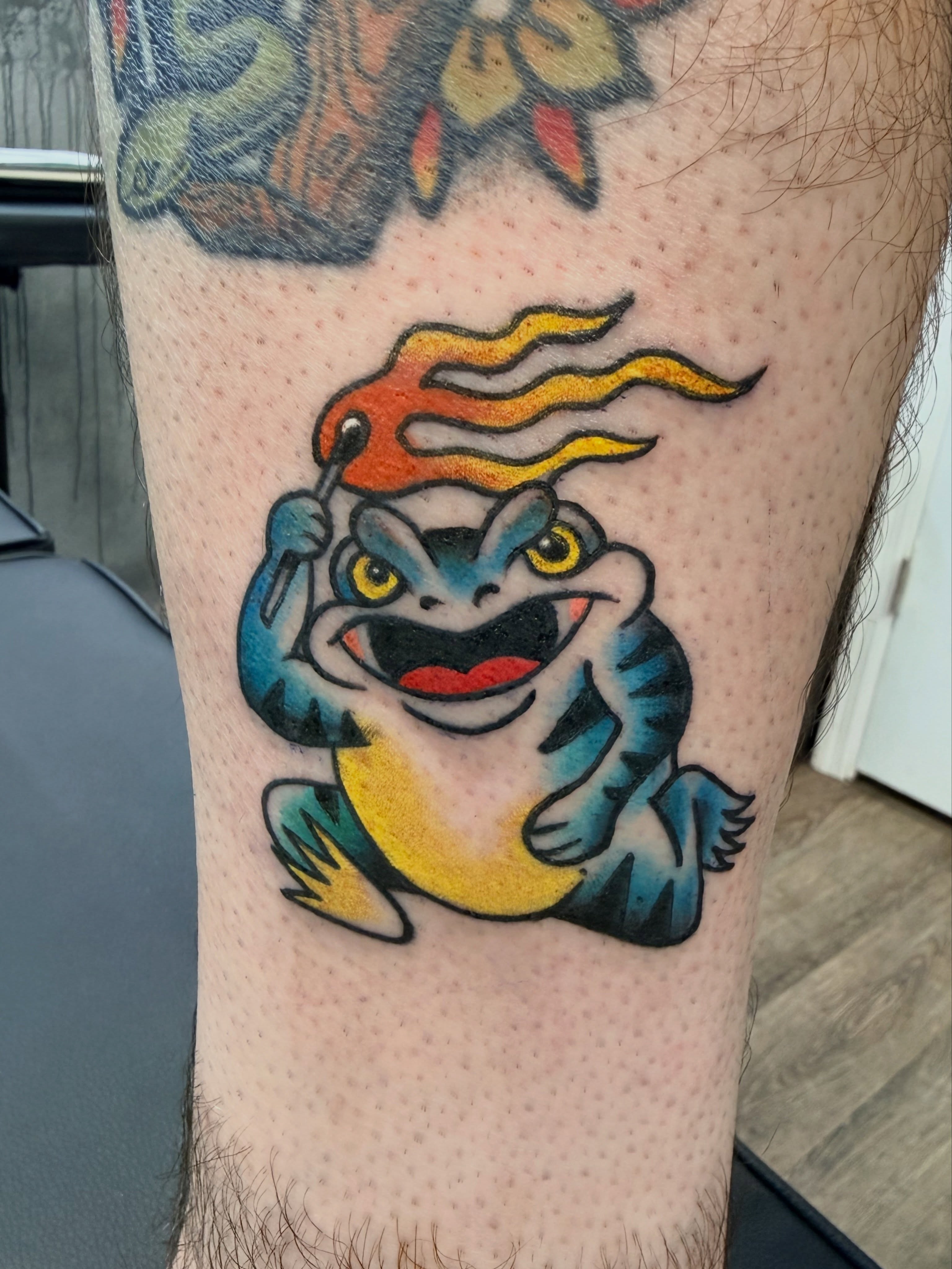 Frog with flame American traditional tattoo on the forearm by Chris