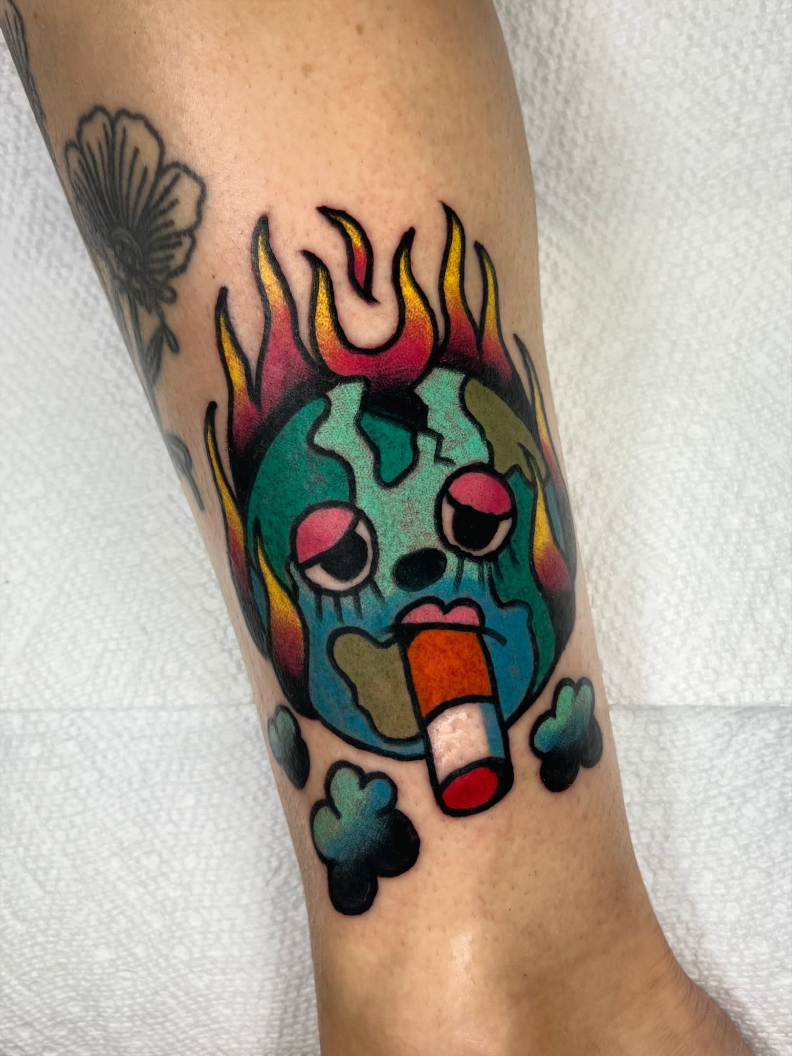 Burning Earth American traditional tattoo on the forearm by Sierra Mack