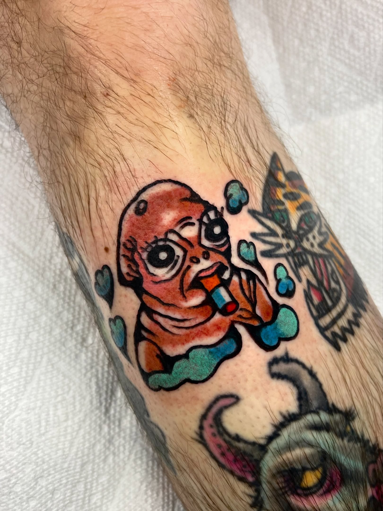Alien baby American traditional tattoo on the forearm by Sierra Mack