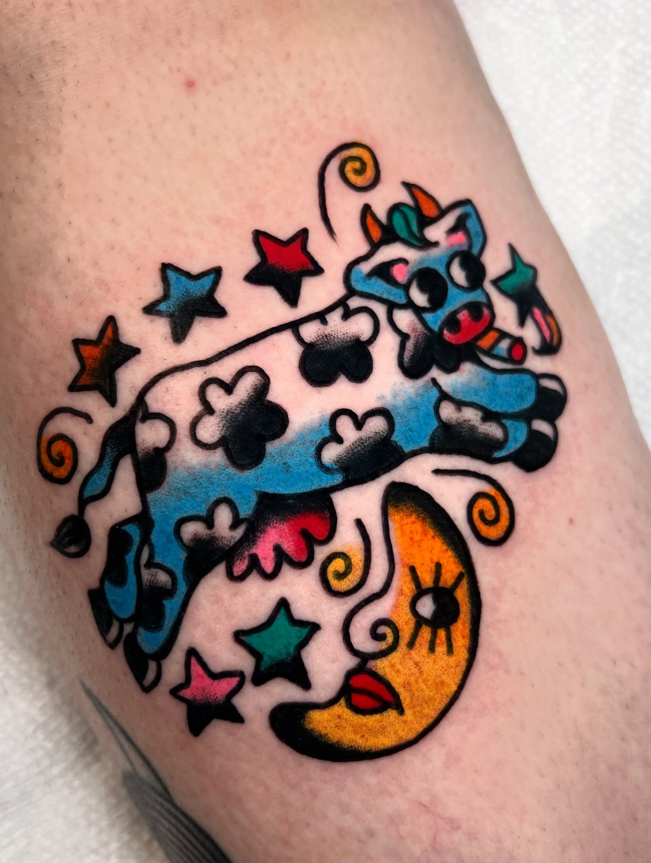 Cow and moon American traditional tattoo on the thigh by Sierra Mack