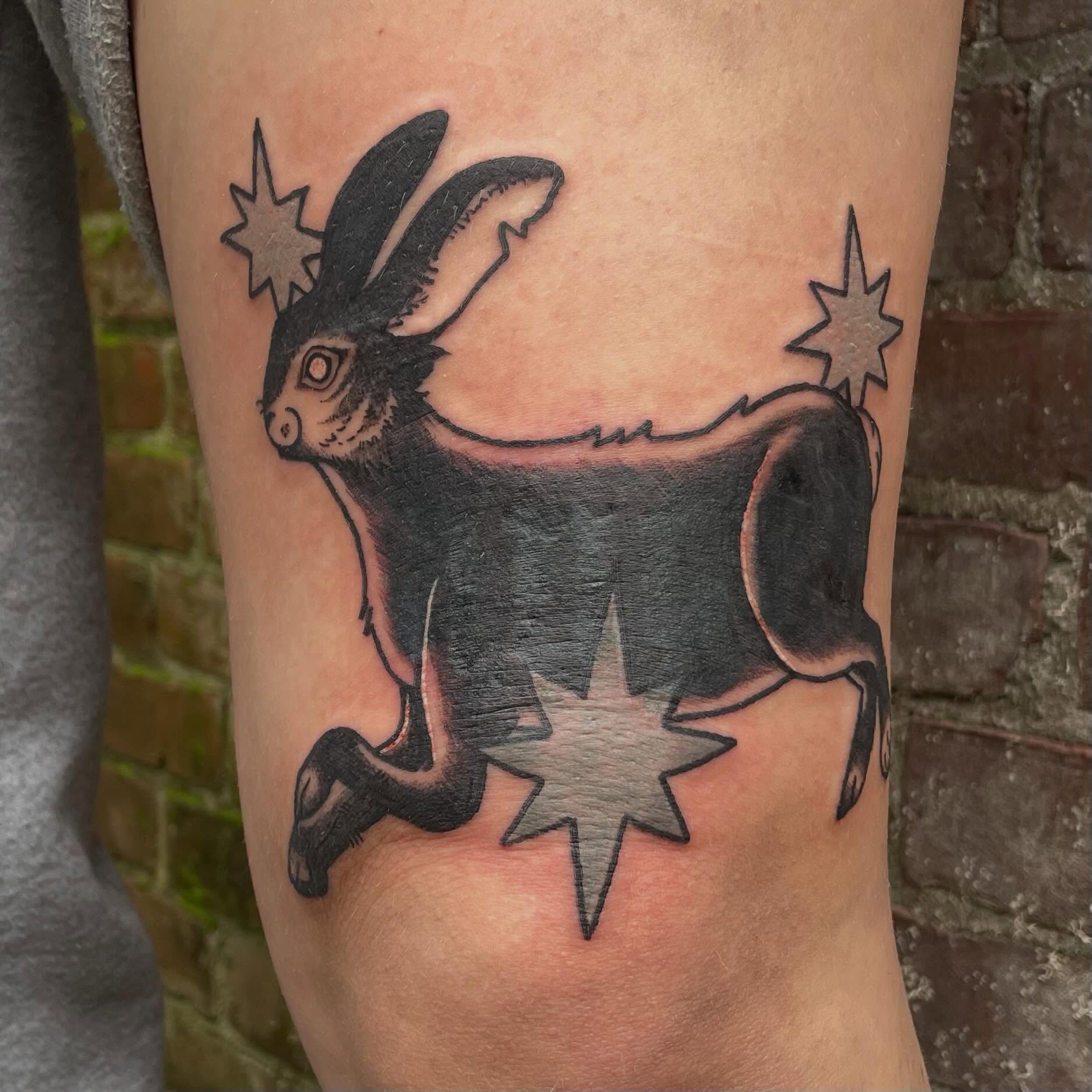 Goat with stars black and grey tattoo on the forearm by Avalon Sable