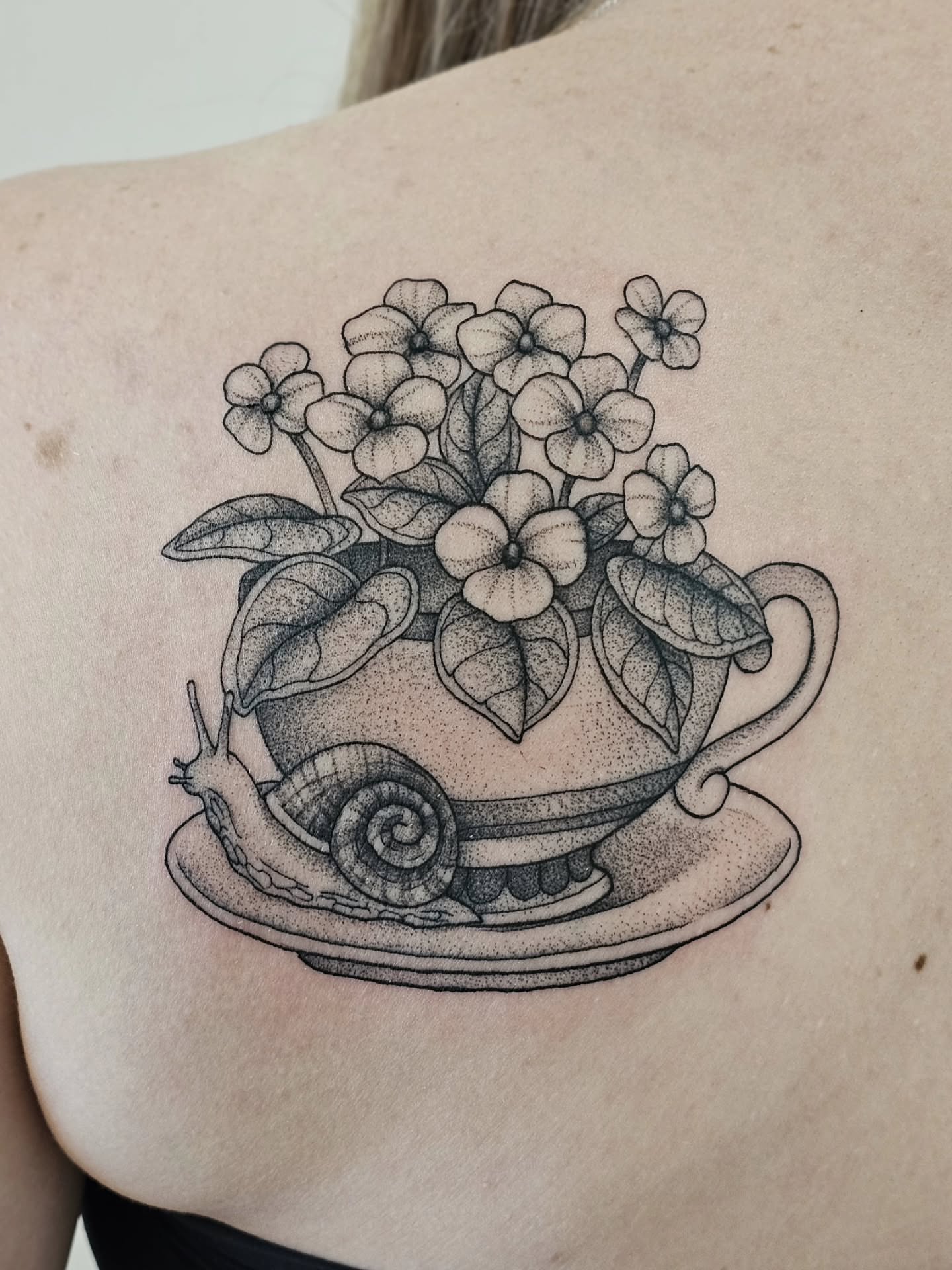 Teacup with flowers dotwork tattoo on the shoulder by Kylie Lund