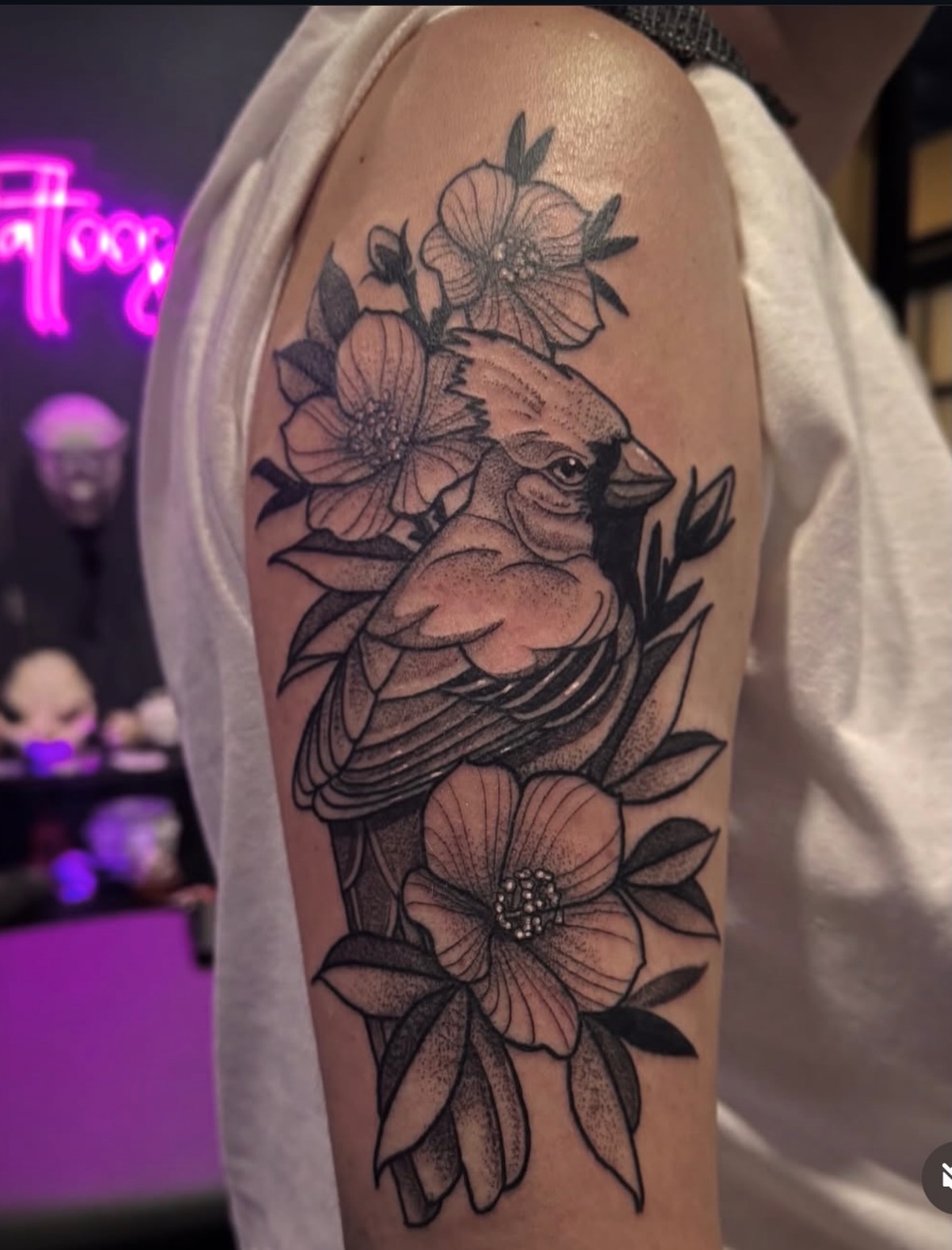 Cardinal and flowers dotwork tattoo on the upper arm by Neotraditional Blackwork