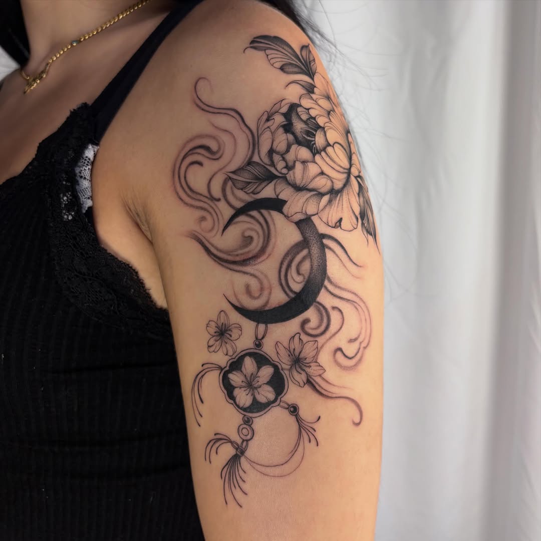 Peony, moon, and charm fine line tattoo on the upper arm by ꩜ 𖦹