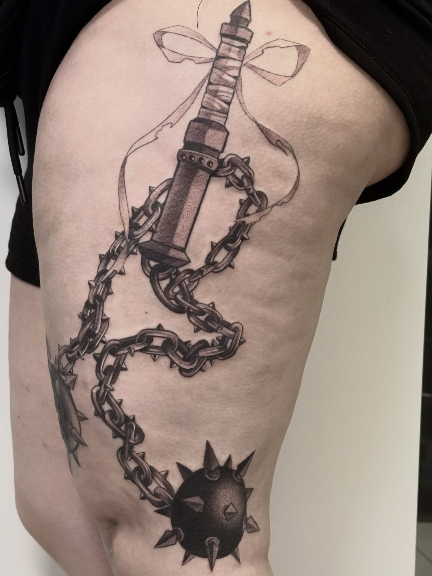 Sword and chain realism tattoo on the thigh by Abrianna