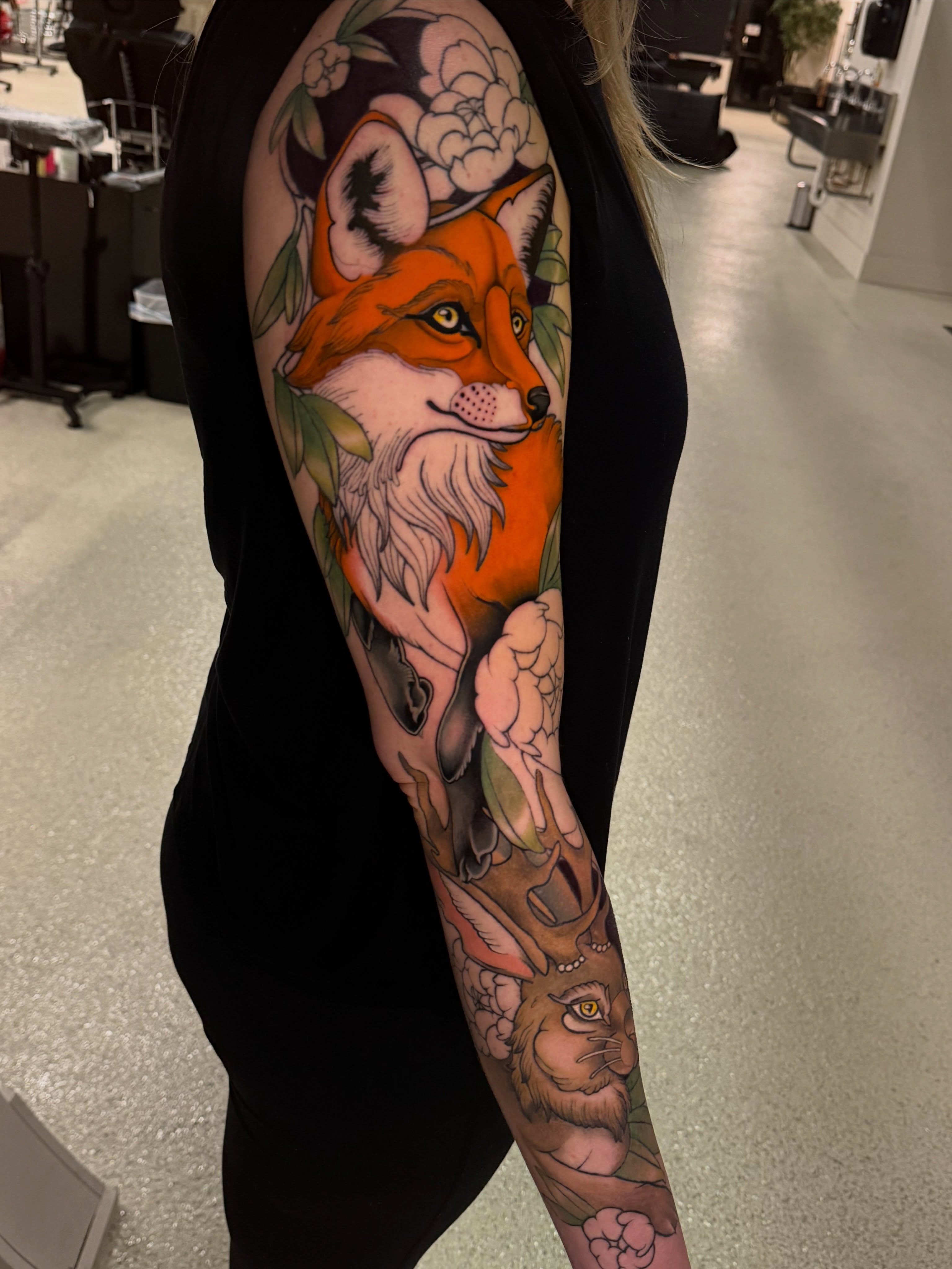 Fox and lion new school tattoo on the forearm by Kelsey Zussman