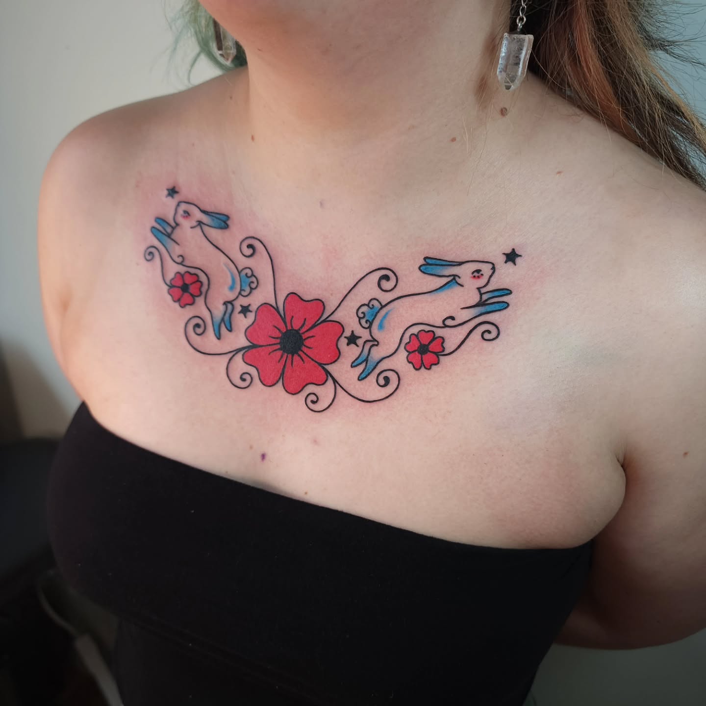 Rabbits and flowers new school tattoo on the chest by Maxine Stewart