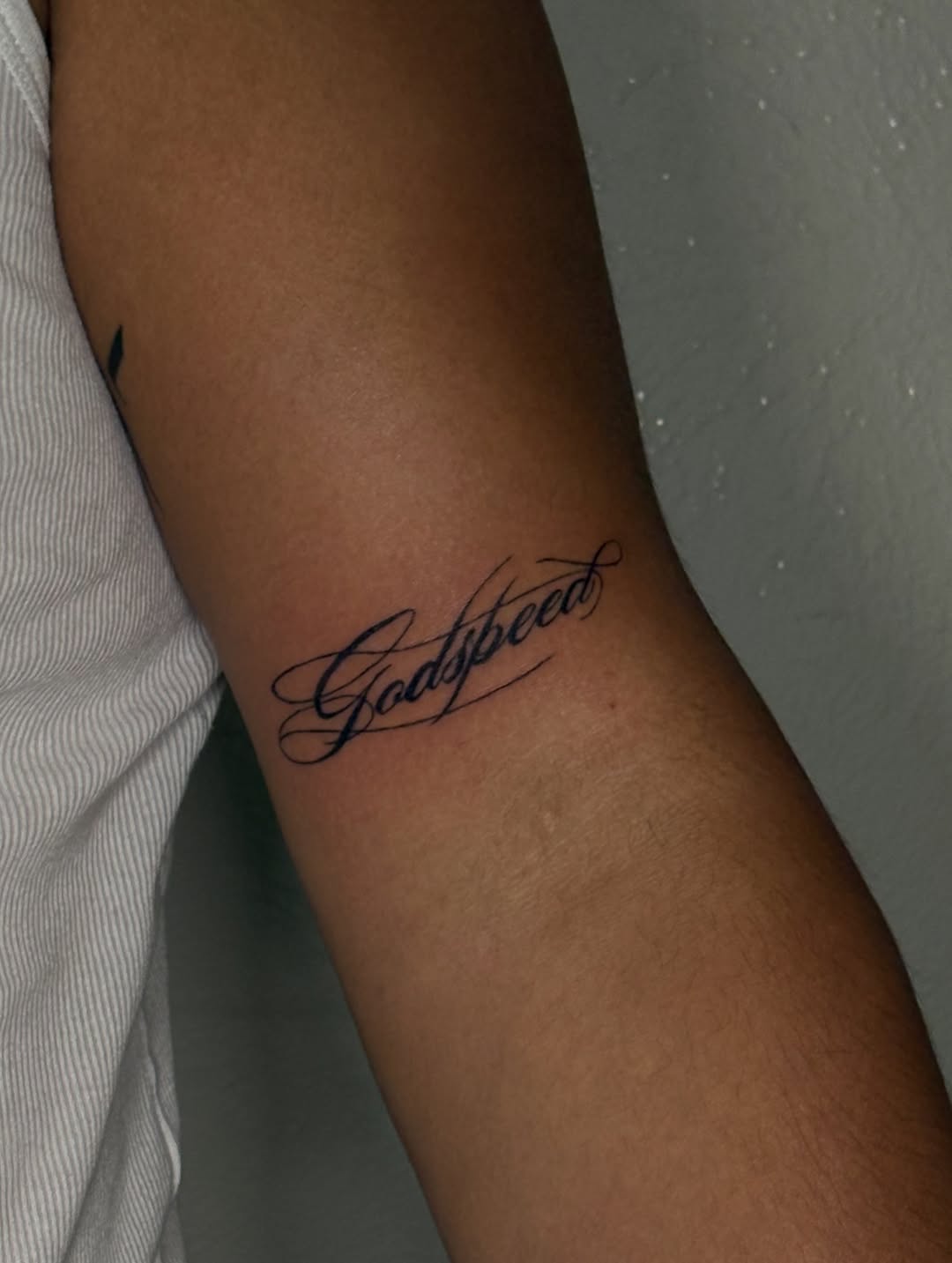 Script lettering lettering tattoo on the forearm by Valentina