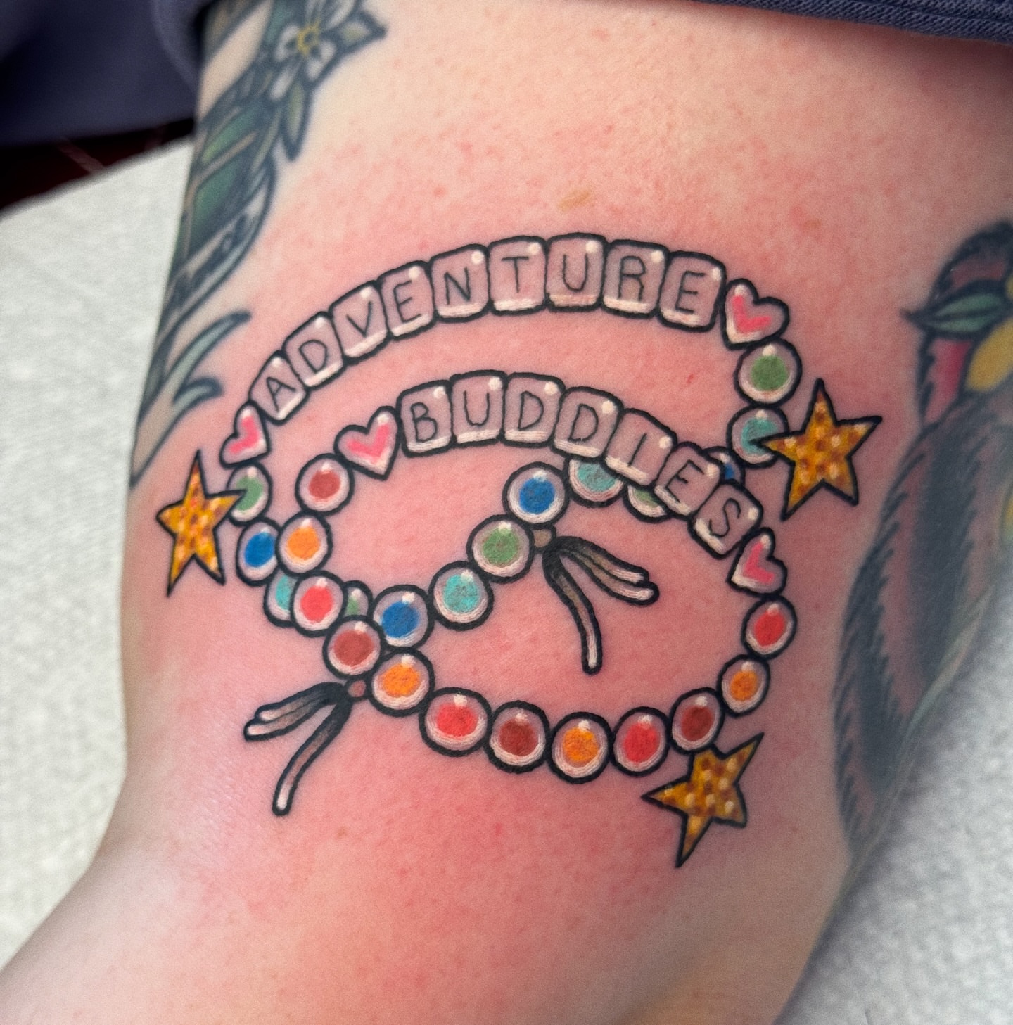 Beaded bracelet with text new school tattoo on the forearm by 𝕷𝖆𝖚𝖗 𝕷𝖆𝖚𝖗