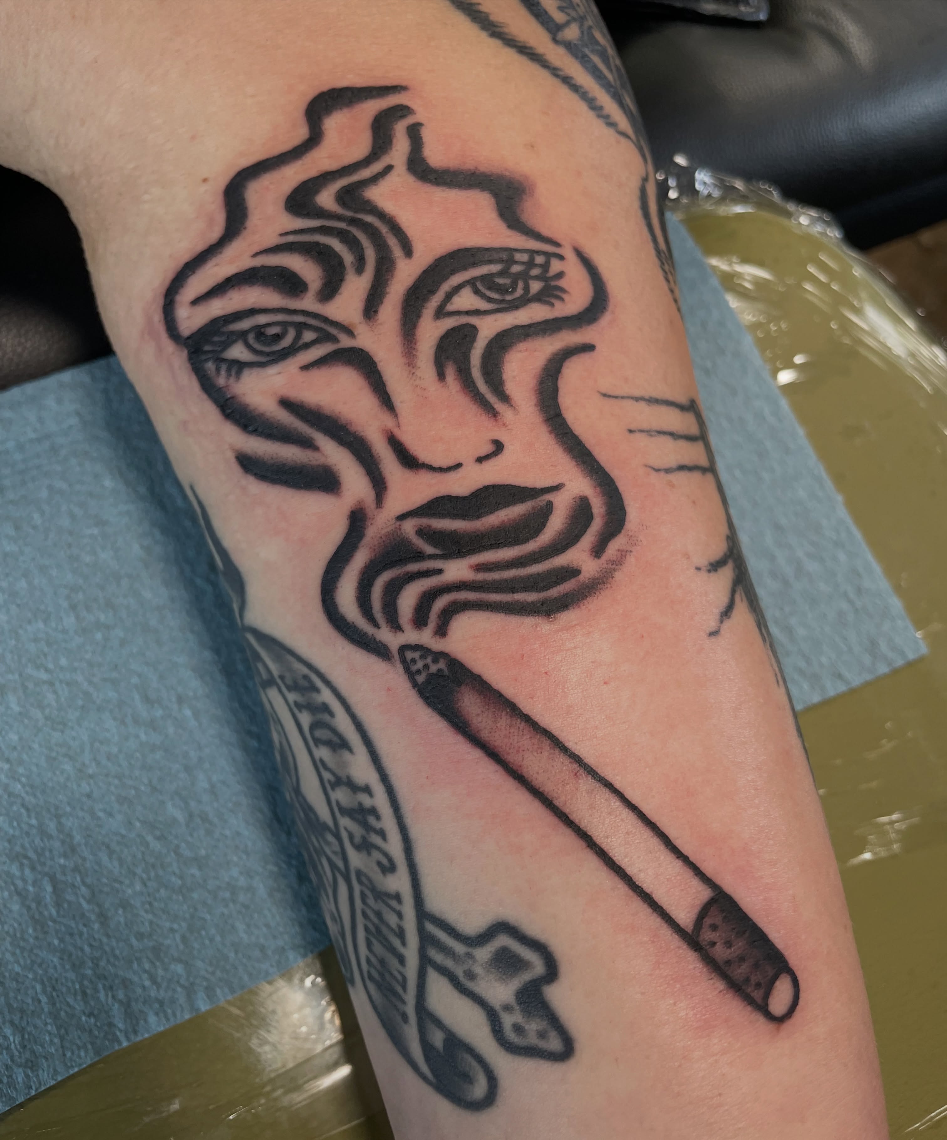 Smoking face black and grey tattoo on the forearm by @pizzabref