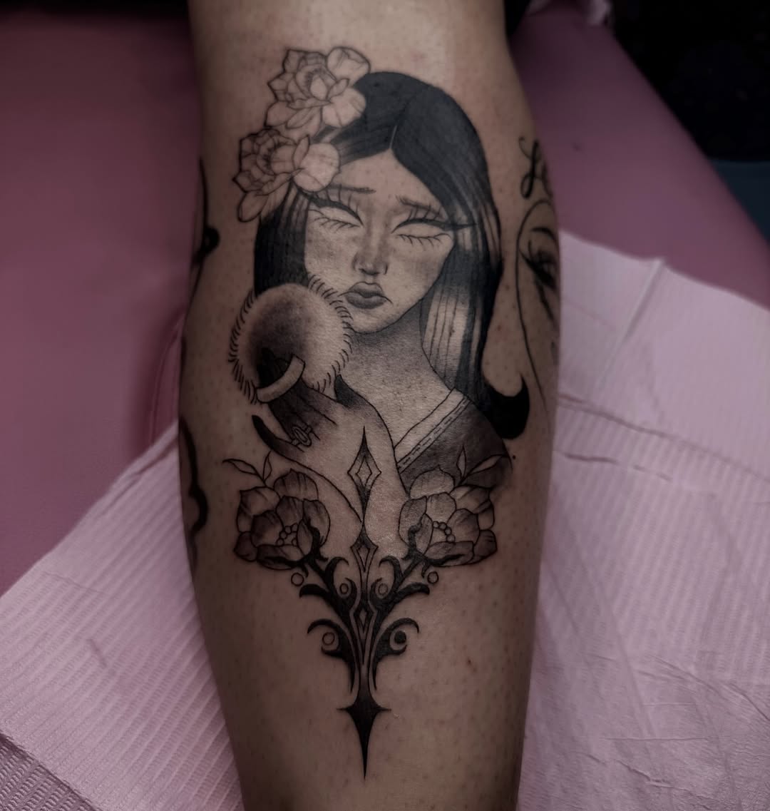 Woman with flowers realism tattoo on the forearm by Weho Tattoo Artist Lupe