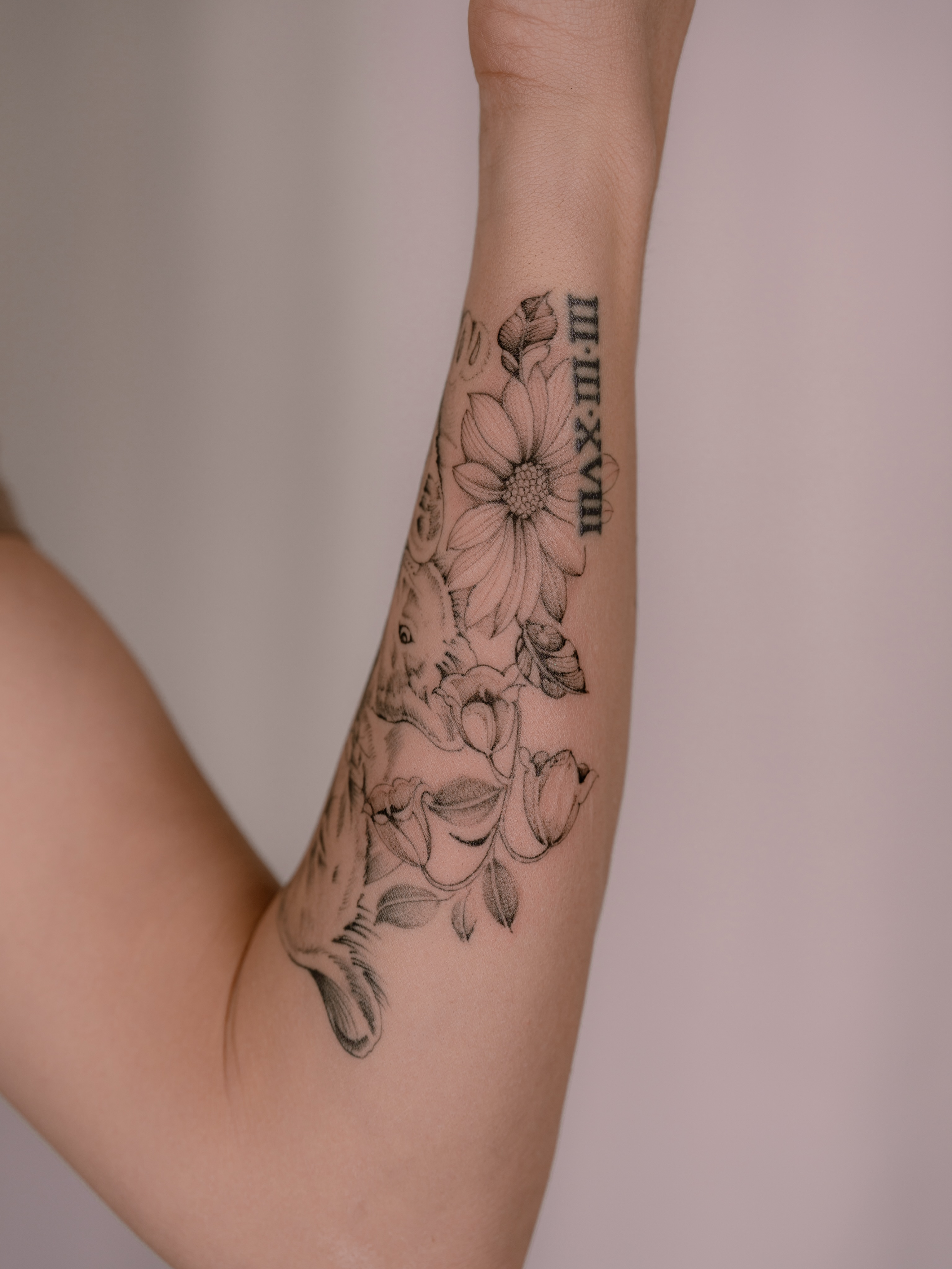 Flower and fish black and grey tattoo on the forearm by Leo Gao