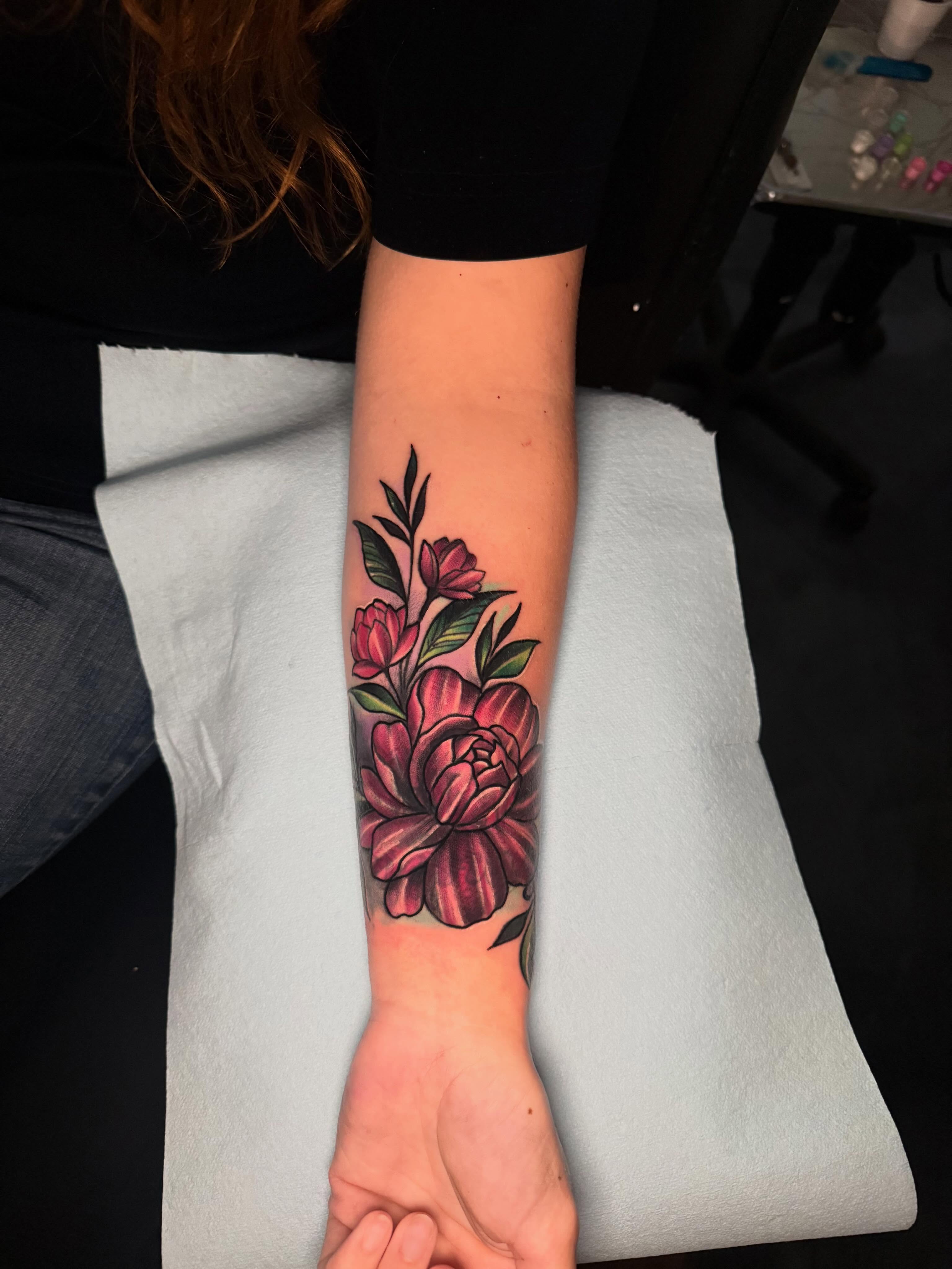 Peony flowers American traditional tattoo on the forearm by Alex Wheelock