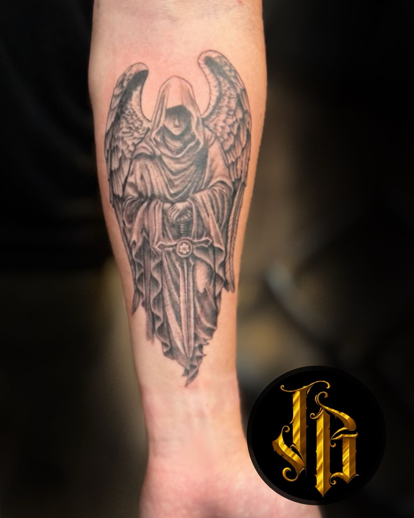 Grim reaper dark realism tattoo on the forearm by James Brooks