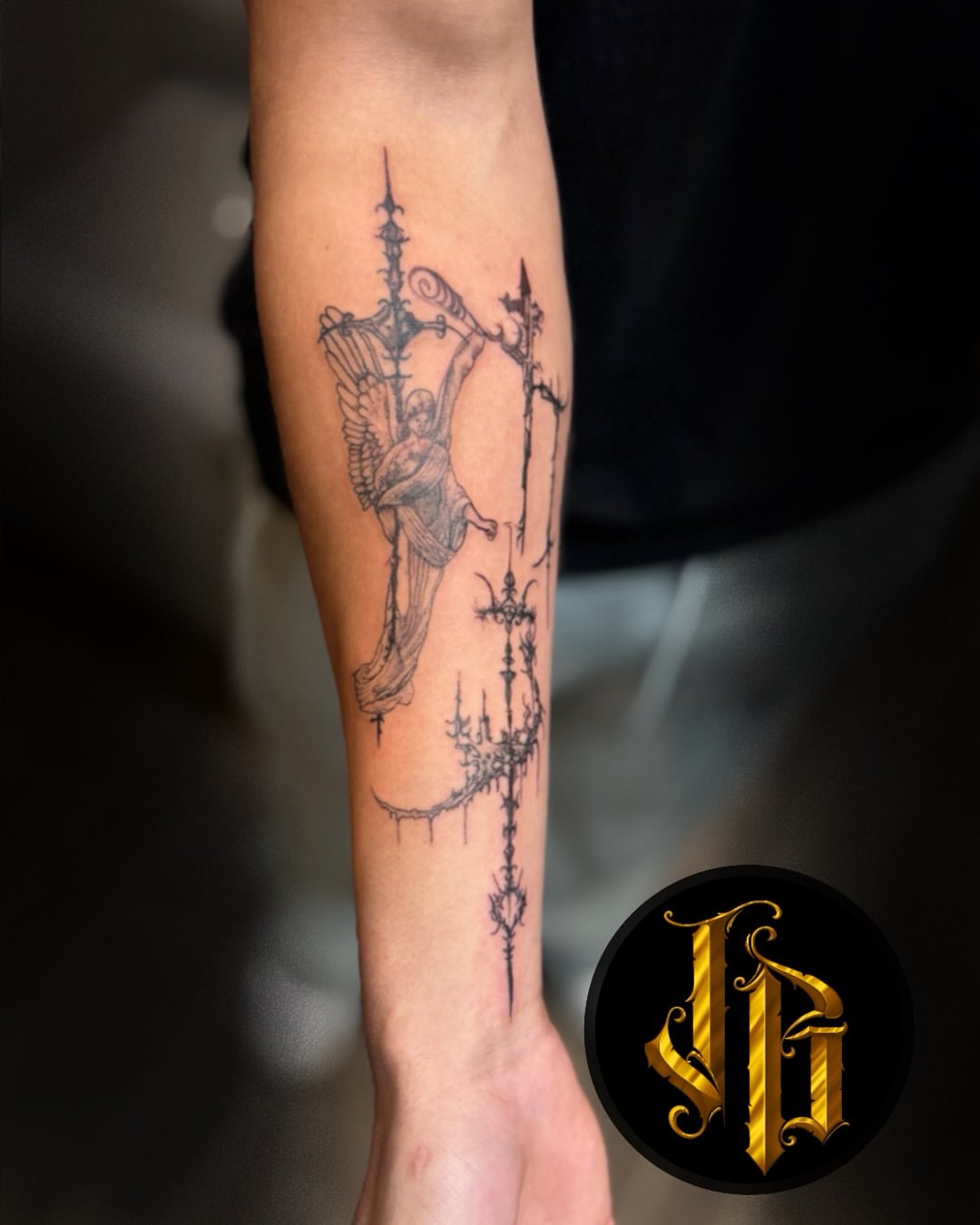 Angelic figure realism tattoo on the forearm by James Brooks