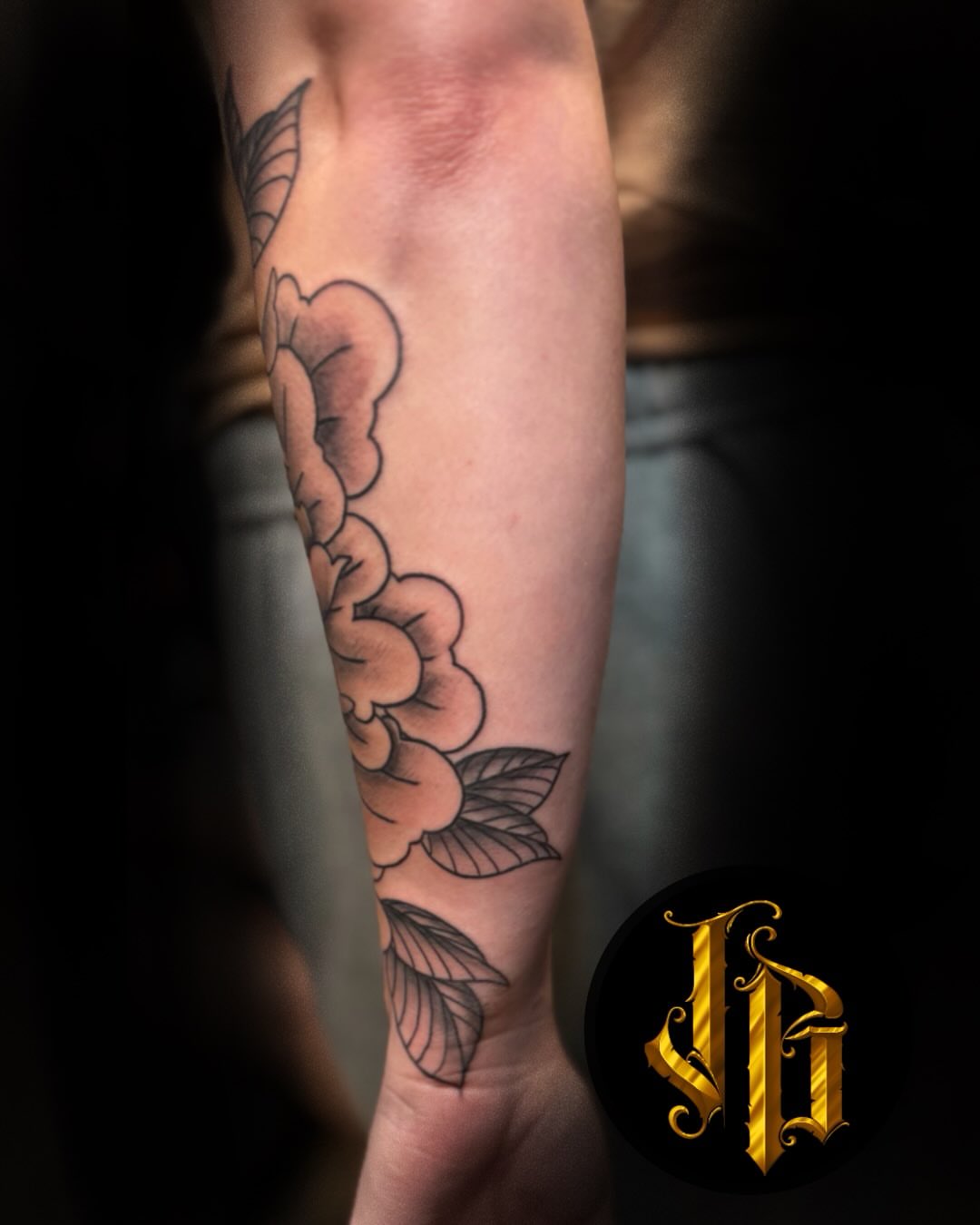 Flower black and grey tattoo on the forearm by James Brooks