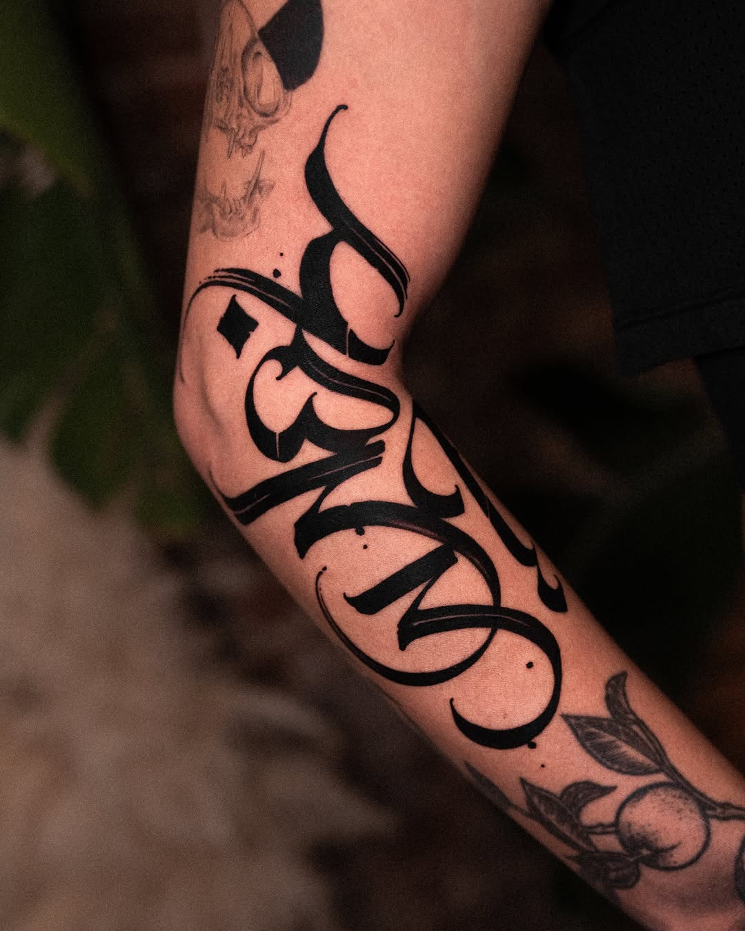 Calligraphy script Chicano tattoo on the forearm by Low, Brooklyn, New York