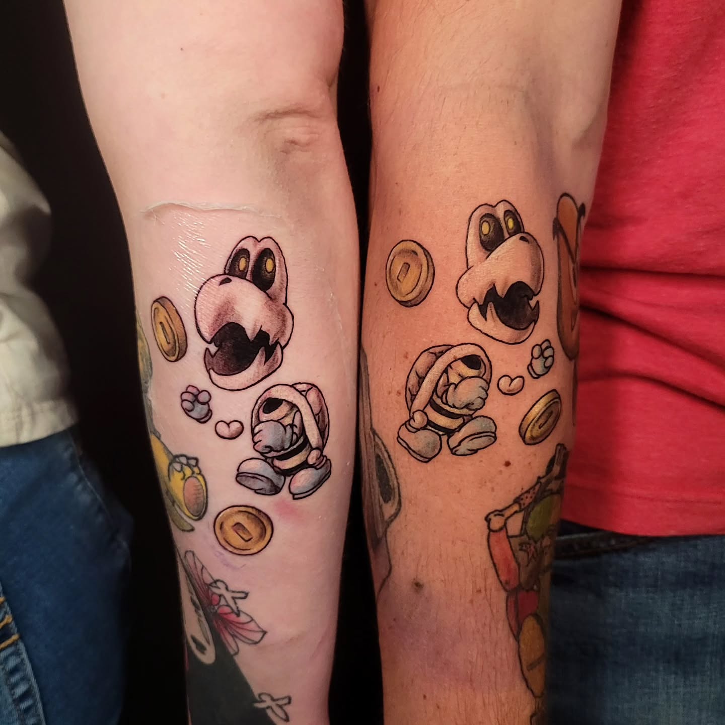 Yoshi and coins dotwork tattoo on the forearm by Sarah Alba