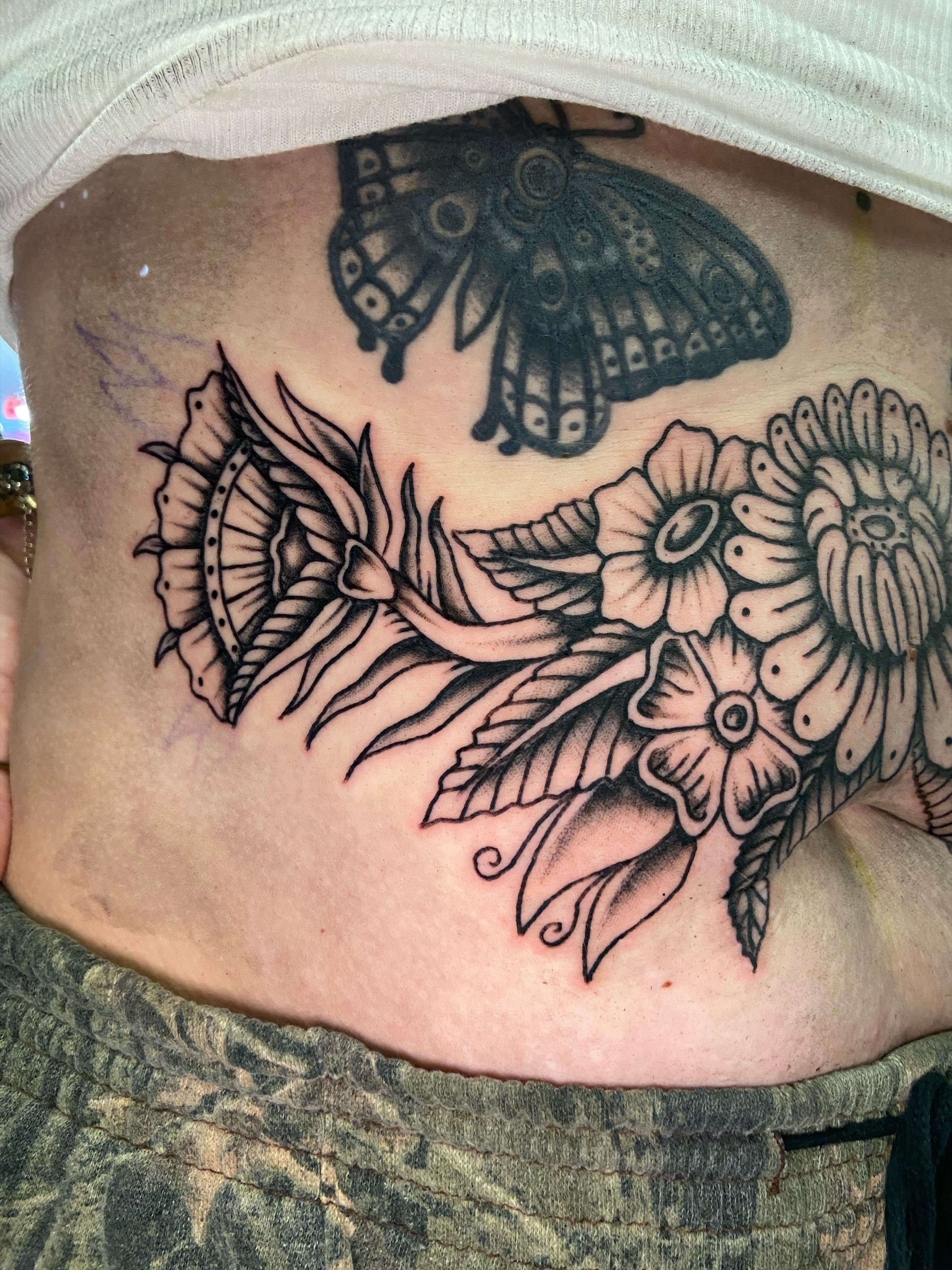 Flowers and butterfly black and grey tattoo on the ribs by R y a n S m i t h