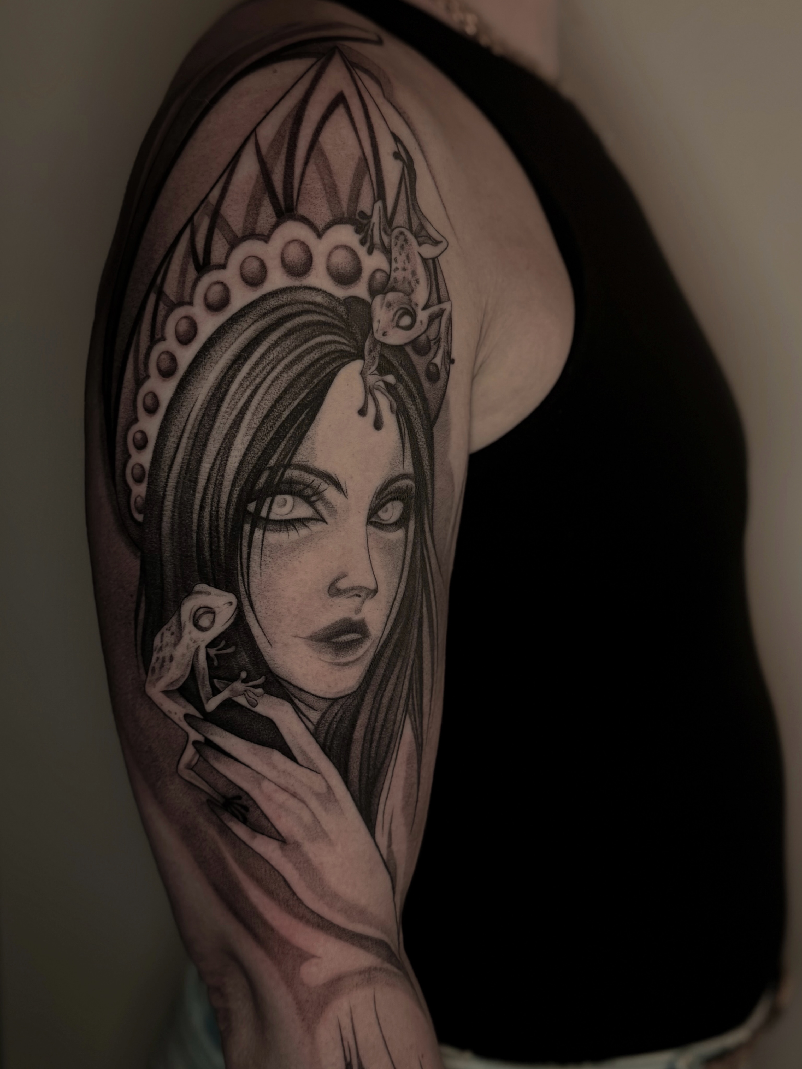 Woman with frog realism tattoo on the shoulder by Kris Tattoo Chicago